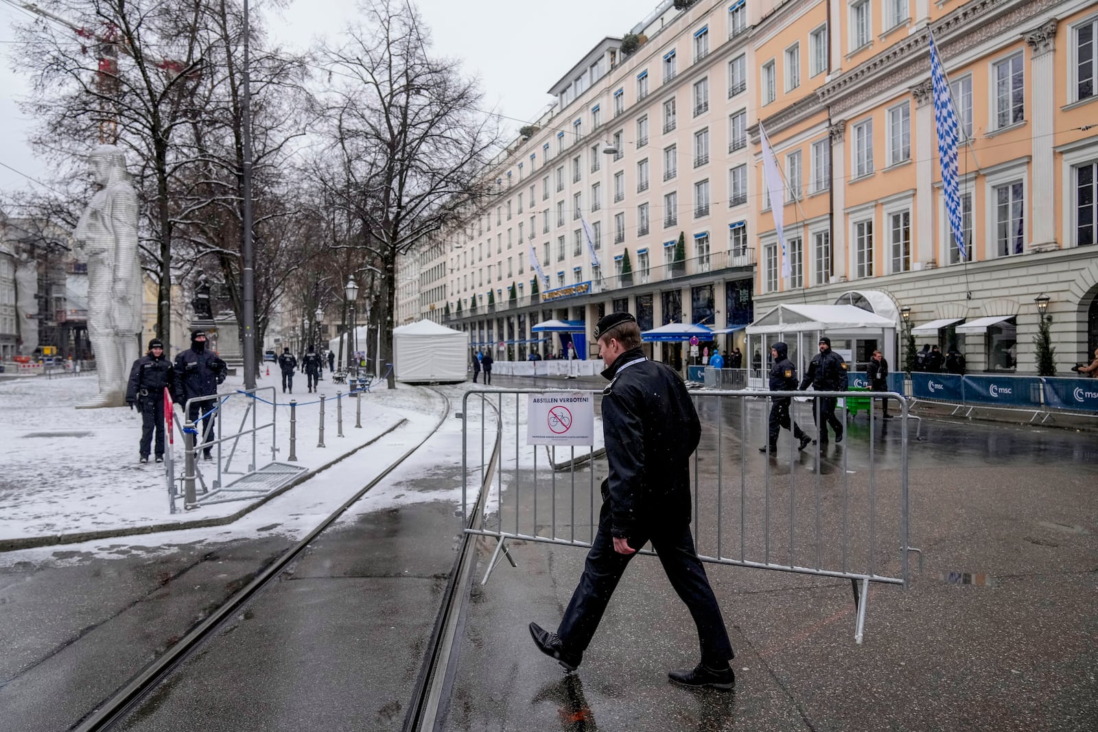 An army member removes a fence on the last day the Munich Security Conference at the Bayerischer Hof Hotel in Munich, Germany, Sunday, Feb. 16, 2025. (AP Photo/Matthias Schrader)