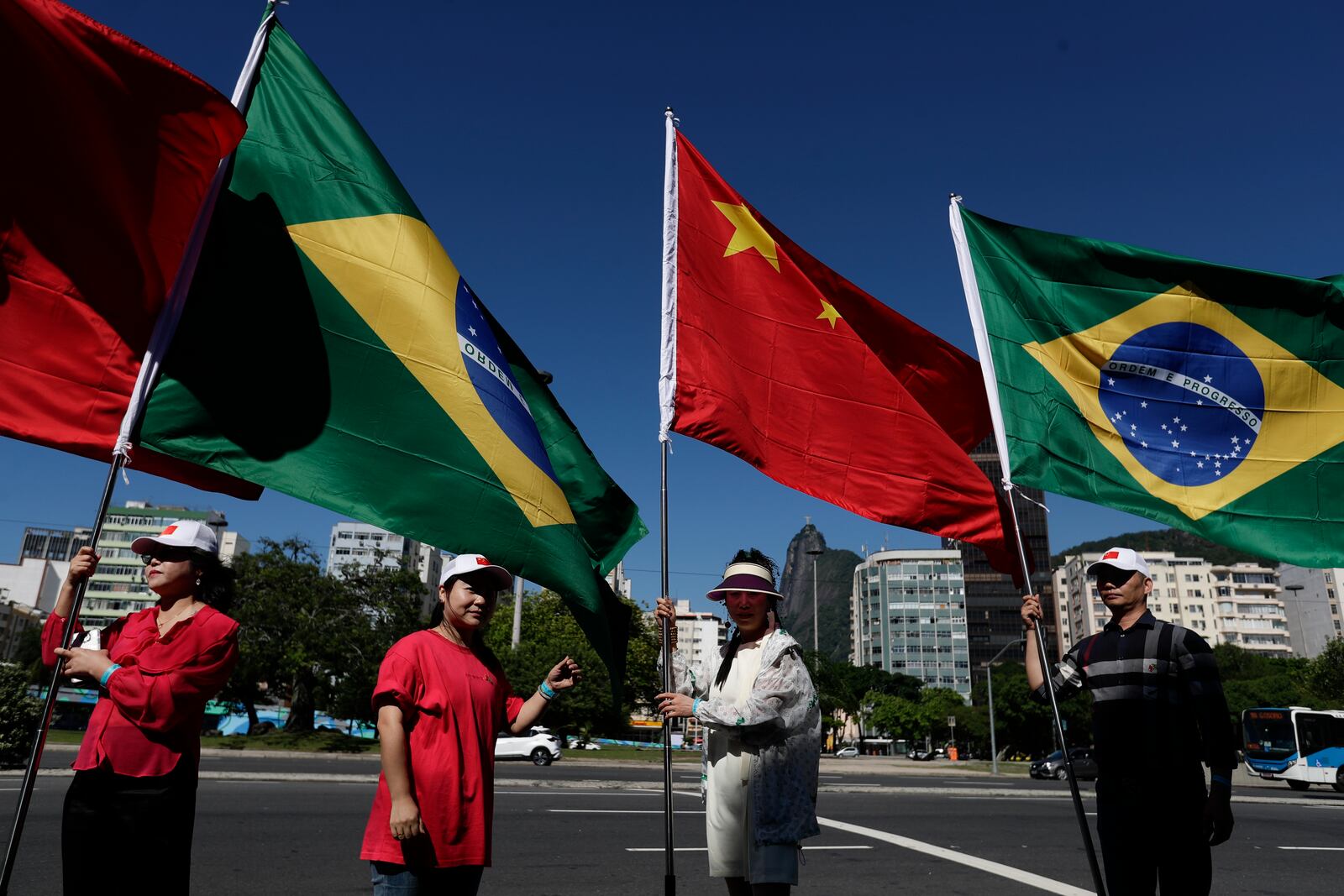 People hold Brazilian and Chinese flags during the G20 Summit in Rio de Janeiro, Monday, Nov. 18, 2024. (AP Photo/Bruna Prado)