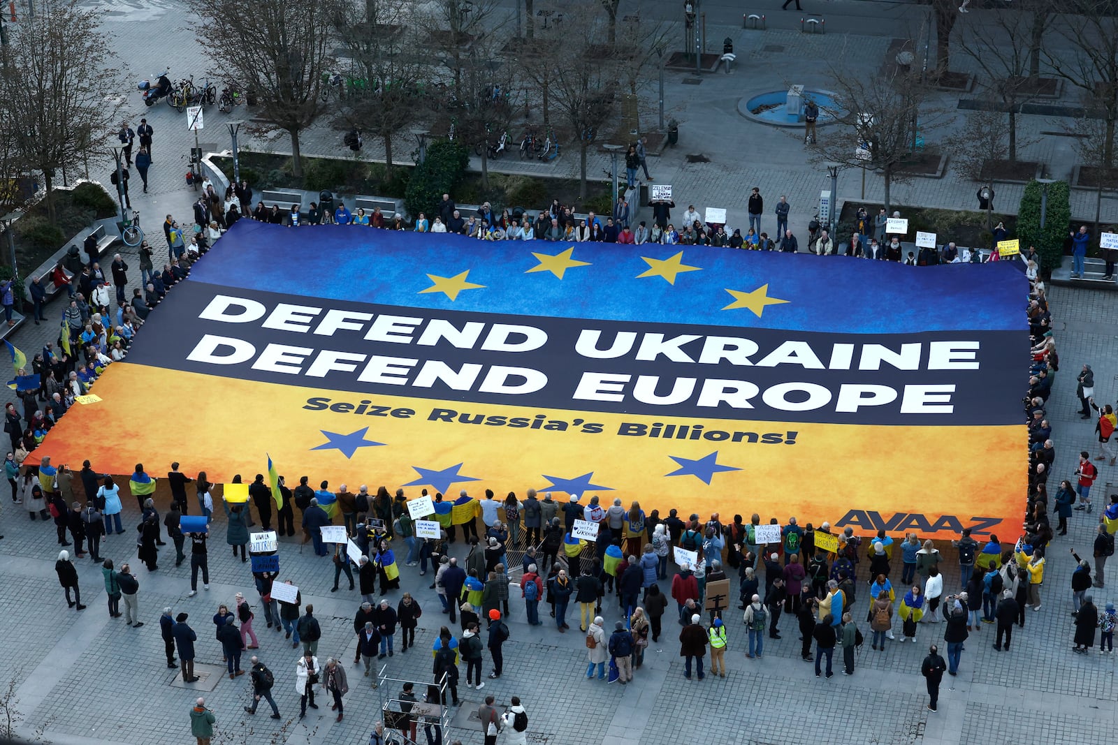 Activists unfurl a large banner in support of Ukraine outside the European Council building ahead of an EU summit in Brussels, Belgium, Wednesday, March 5, 2025. (AP Photo/Omar Havana)