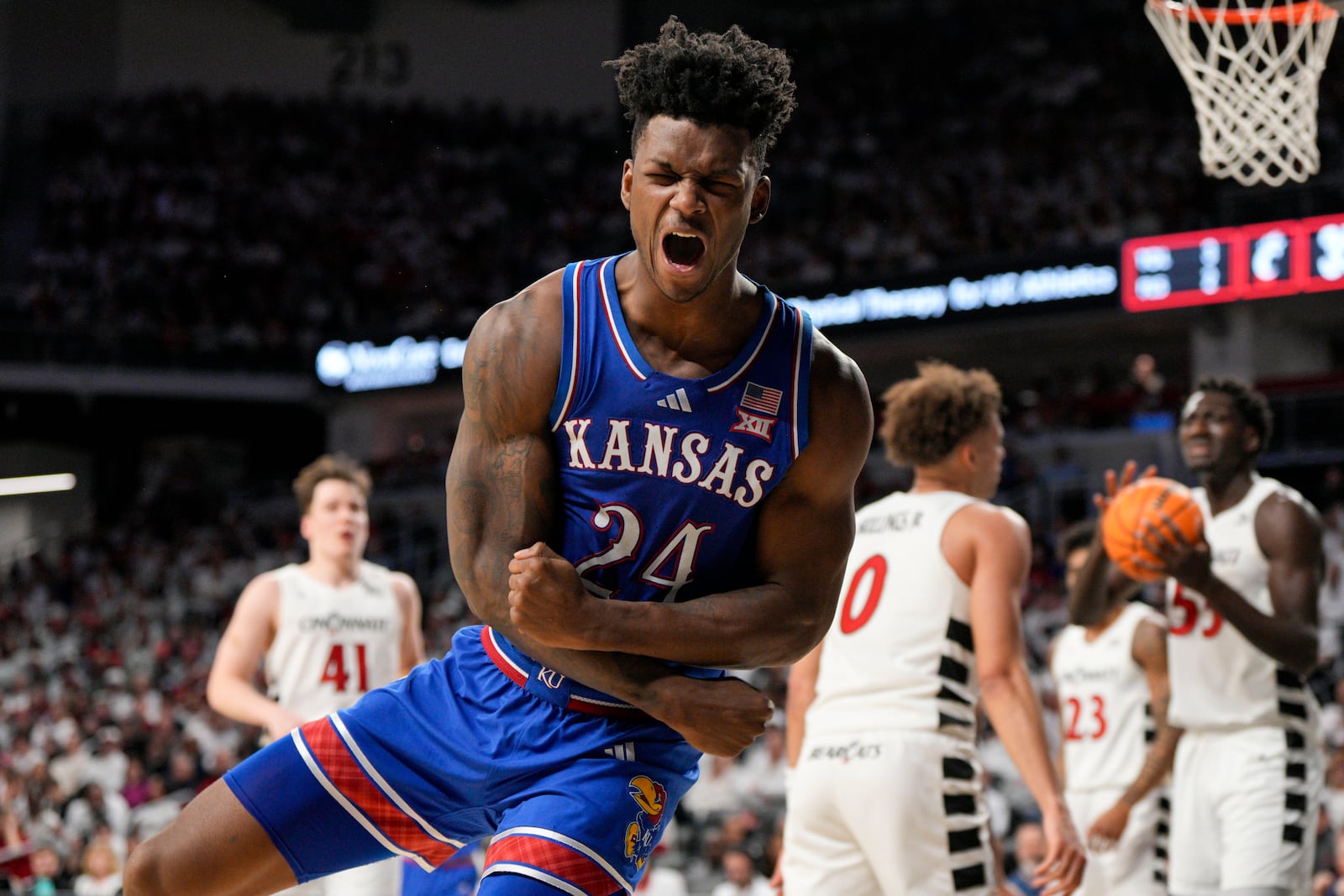 Kansas forward KJ Adams Jr. (24) reacts after scoring during the second half of an NCAA college basketball game against Cincinnati, Saturday, Jan. 11, 2025, in Cincinnati. (AP Photo/Jeff Dean)