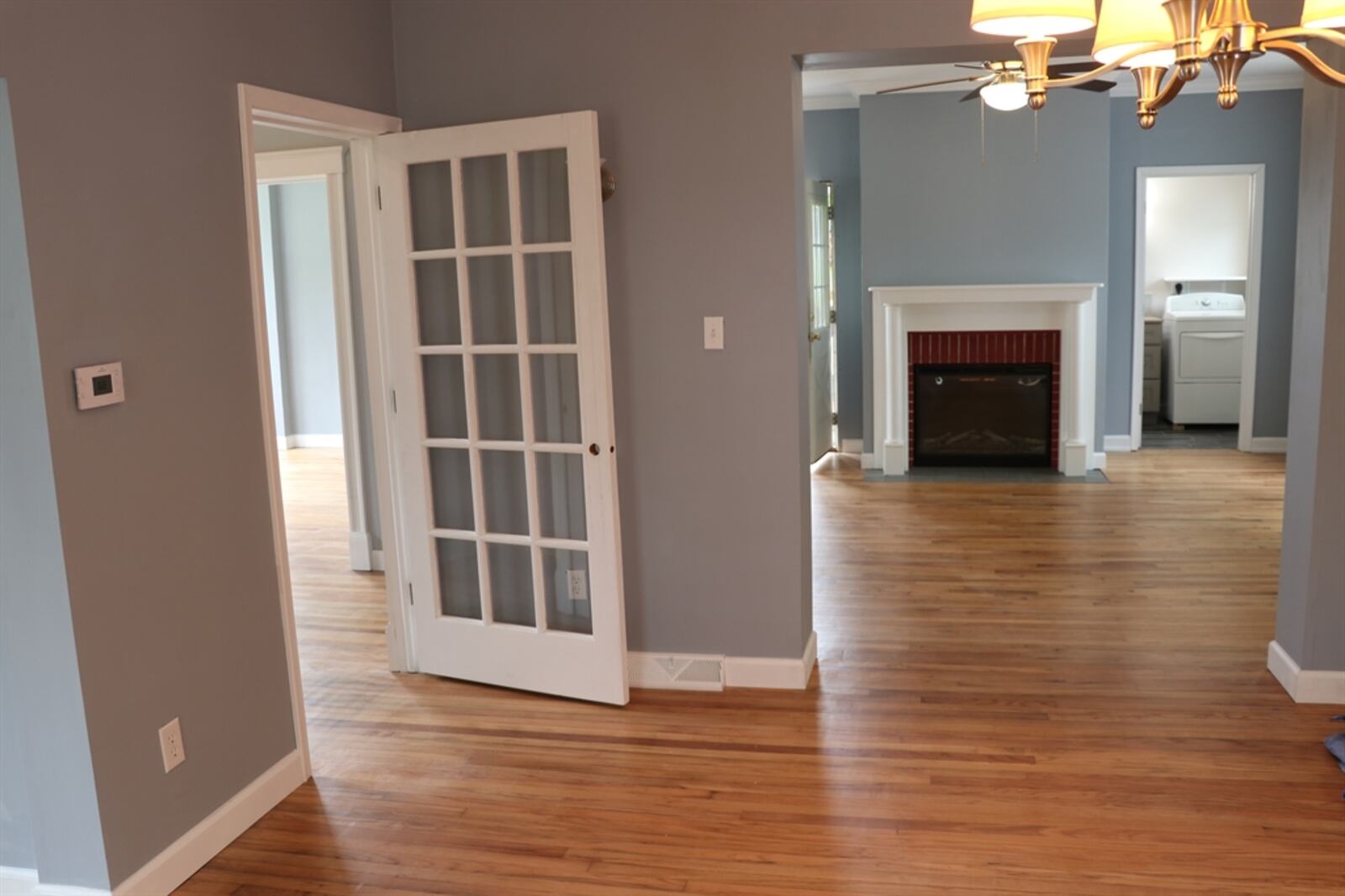 A fireplace was reworked with an electric insert while the mantel and brick surround was restored. The side entry off the covered porch leads directly into the living room. The living room transitions into the formal dining room, which has an entrance door to a privacy patio. Contributed photo 