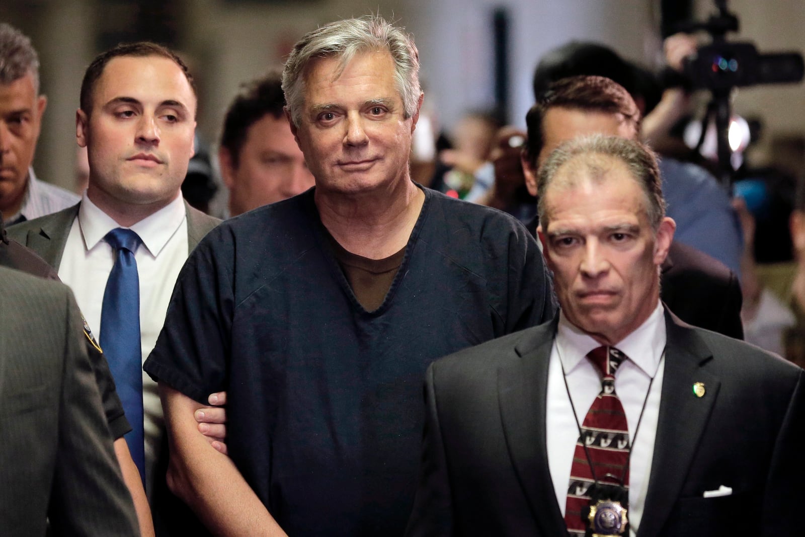 FILE- In this June 27, 2019 file photo, Paul Manafort, center, arrives at court in New York.  New York City prosecutors are seeking to have the state’s highest court revive state mortgage fraud charges against Manafort after striking out twice before in lower courts. The Manhattan district attorney’s office sent a letter Tuesday, Nov. 24, 2020, to the state’s chief judge asking permission to challenge an intermediate appeals court’s ruling last month, which upheld a judge’s decision to dismiss the case on double jeopardy grounds.(AP Photo/Seth Wenig, File)