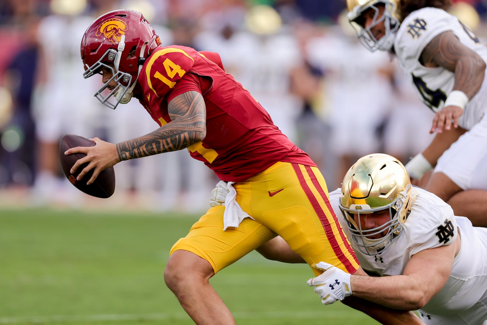 Southern California quarterback Jayden Maiava, left, is sacked by Notre Dame defensive lineman Gabriel Rubio during the first half of an NCAA football game Saturday, Nov. 30, 2024, in Los Angeles. (AP Photo/Ryan Sun)