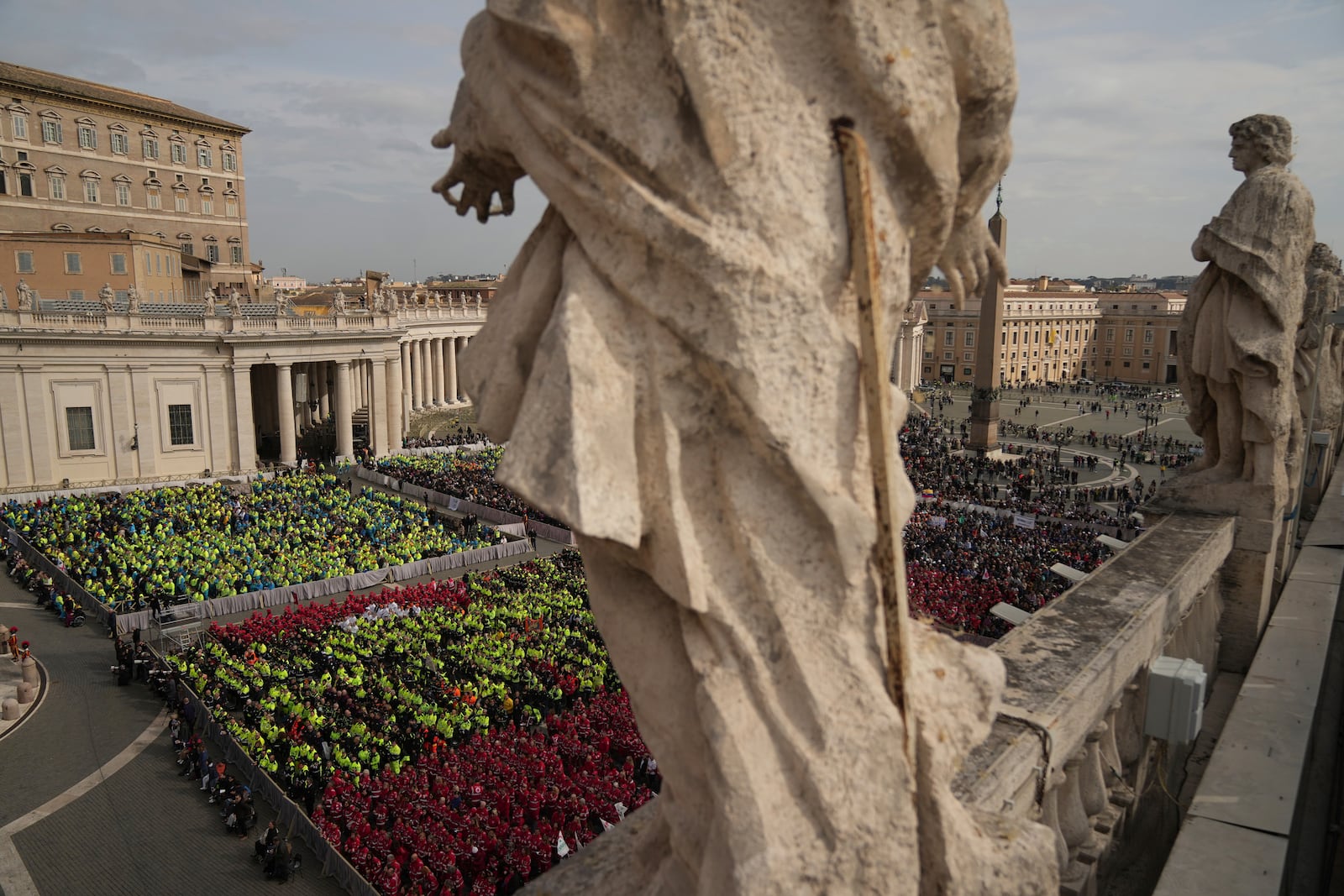 Members of different organizations of volunteers follow Cardinal Michael Czerny, delegate of Pope Francis who is being treated for pneumonia at Rome's Agostino Gemelli Polyclinic, celebrating a mass for the world of volunteers in St. Peter's Square at The Vatican, Sunday, March 9, 2025. (AP Photo/Francisco Seco)