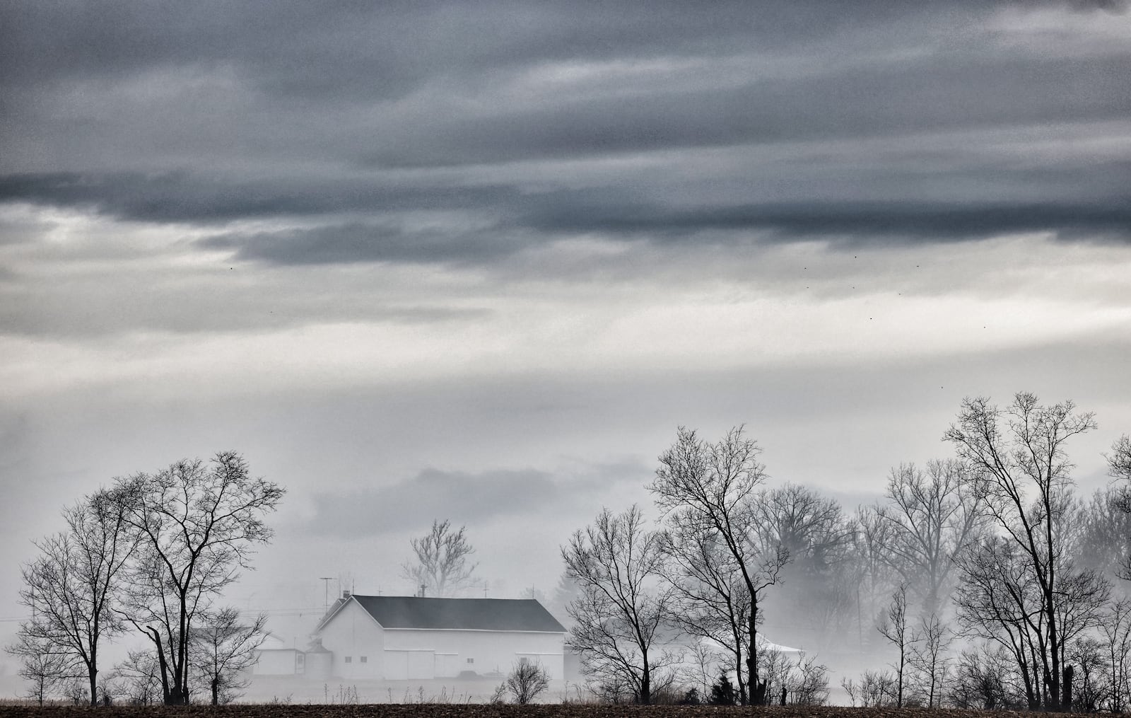 Rain and warm air moves across snow-covered fields Thursday morning, Feb. 17, 2022, in western Montgomery County. JIM NOELKER/STAFF