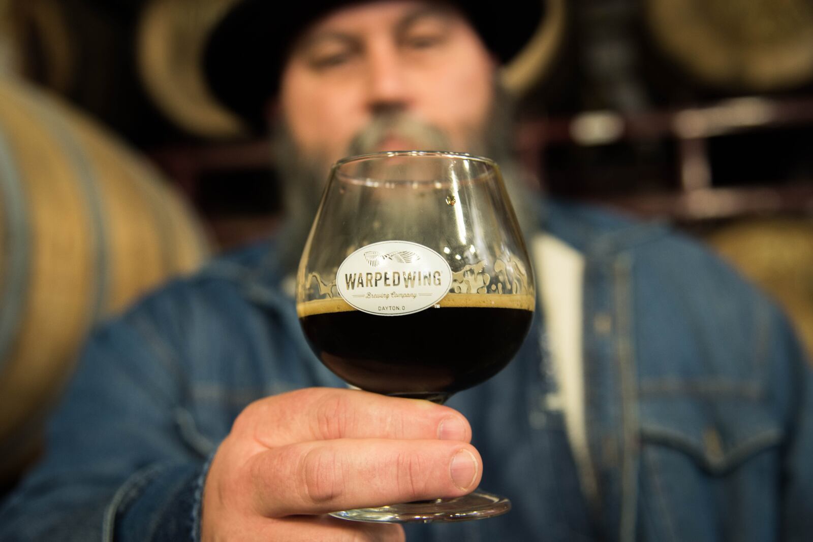 Warped Wing Brewing Co. and the Century Bar have partner for  Kette's Pride. The rye whiskey barrel aged porter will be the only beer sold in Kette's Kandies Spirited Treats.  Joseph Head, the co-owner of the Century Bar is pictured with a glass of Warped Wing beer.  Photo: Submitted by Warped Wing.