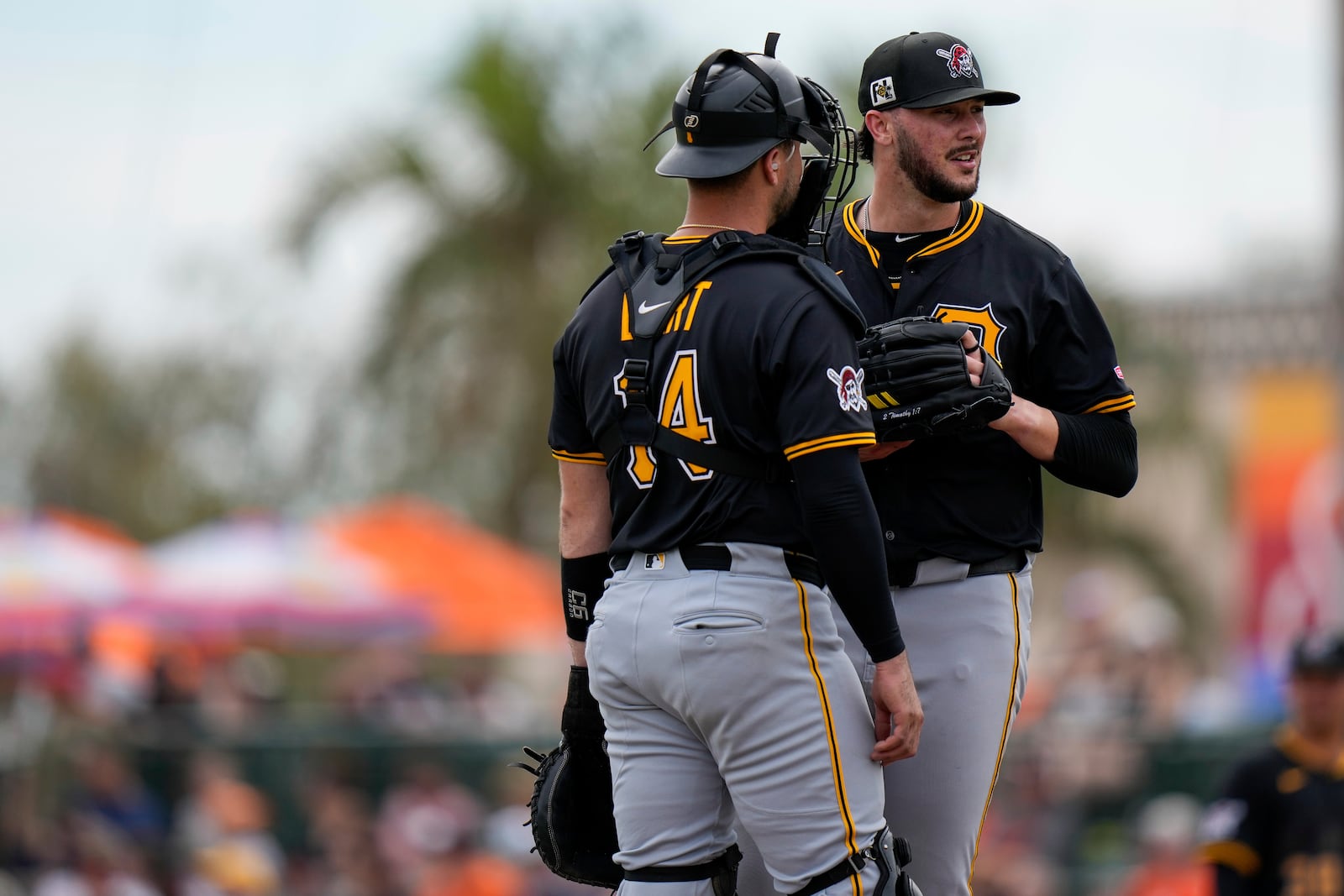 Pittsburgh Pirates catcher Joey Bart (14) talks with starting pitcher Paul Skenes, right, during a mound visit in the third inning of a spring training baseball game against the Baltimore Orioles, Saturday, March 1, 2025, in Sarasota, Fla. (AP Photo/Stephanie Scarbrough)