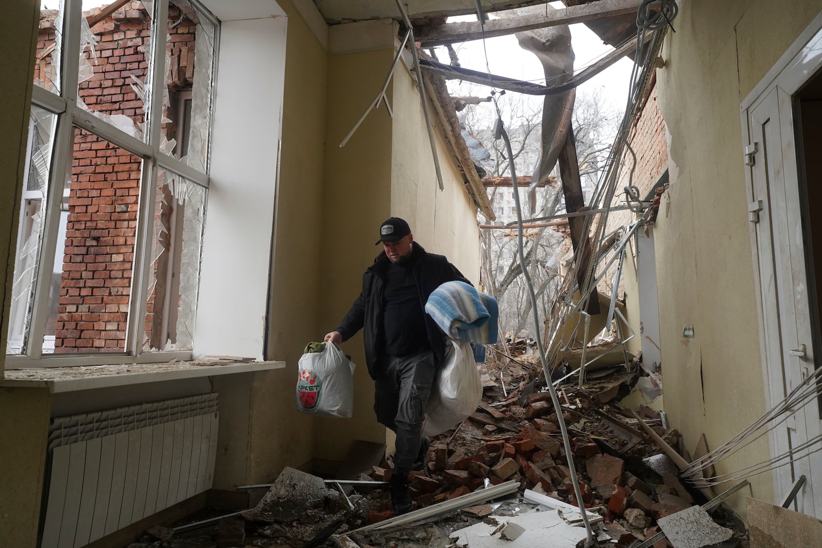 A man walks inside a hospital damaged by a Russian strike, in Kharkiv, Ukraine, March 1, 2025. (AP Photo/Andrii Marienko)