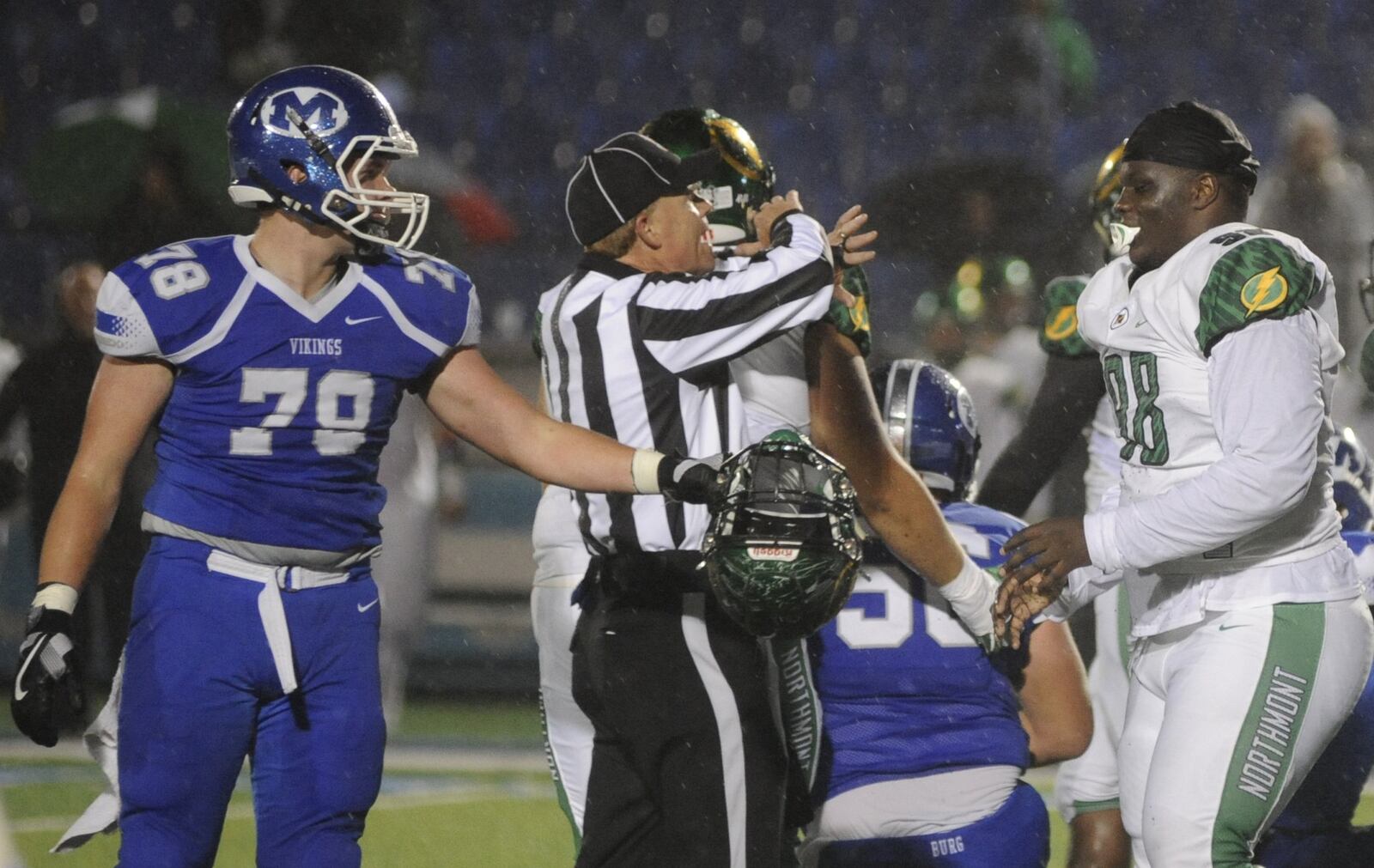 Colin Alcorn of Miamisburg (left) returns a helmet to Northmont s Jamar Walder. Northmont defeated host Miamisburg 21-6 in a Week 10 high school football game on Friday, Oct. 26, 2018. MARC PENDLETON / STAFF