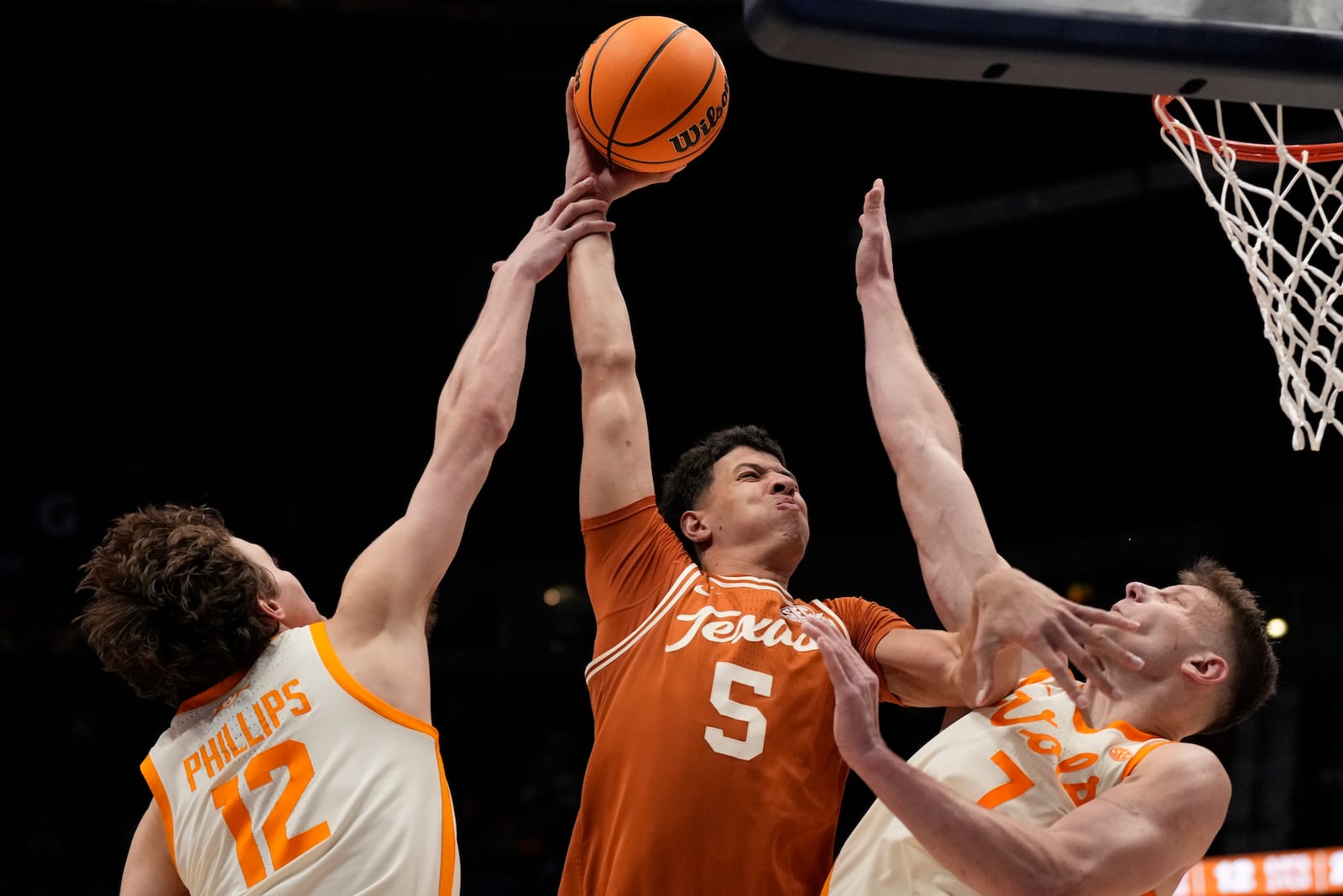 Texas forward Kadin Shedrick (5) shoots over Tennessee's Cade Phillips (12) Igor Milicic Jr. (7) during the second half of an NCAA college basketball game in the quarterfinal round of the Southeastern Conference tournament, Friday, March 14, 2025, in Nashville, Tenn. (AP Photo/George Walker IV)