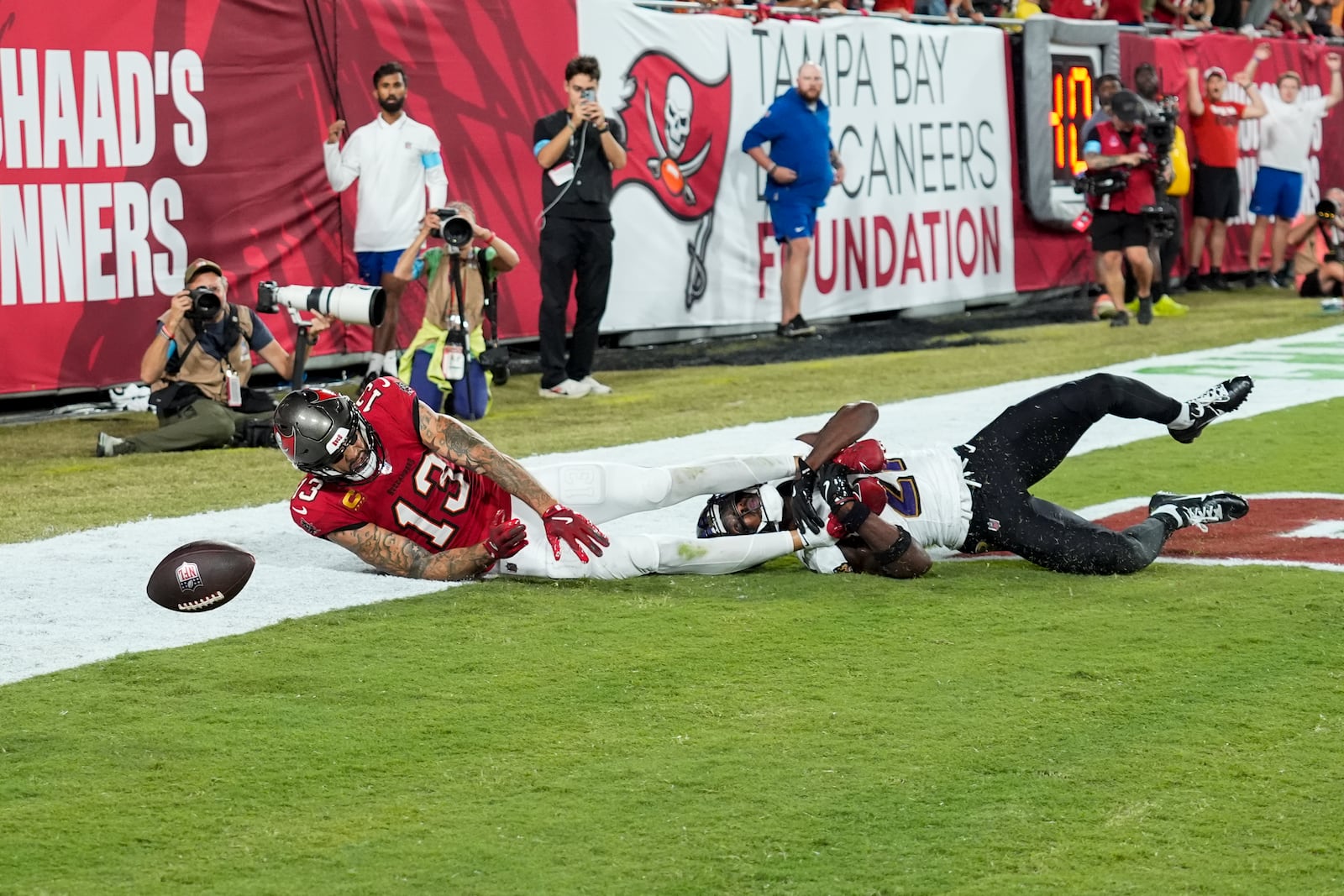 Baltimore Ravens cornerback Brandon Stephens (21) breaks up a pass intended for Tampa Bay Buccaneers wide receiver Mike Evans (13) during the first half of an NFL football game, Monday, Oct. 21, 2024, in Tampa, Fla. (AP Photo/Chris O'Meara)