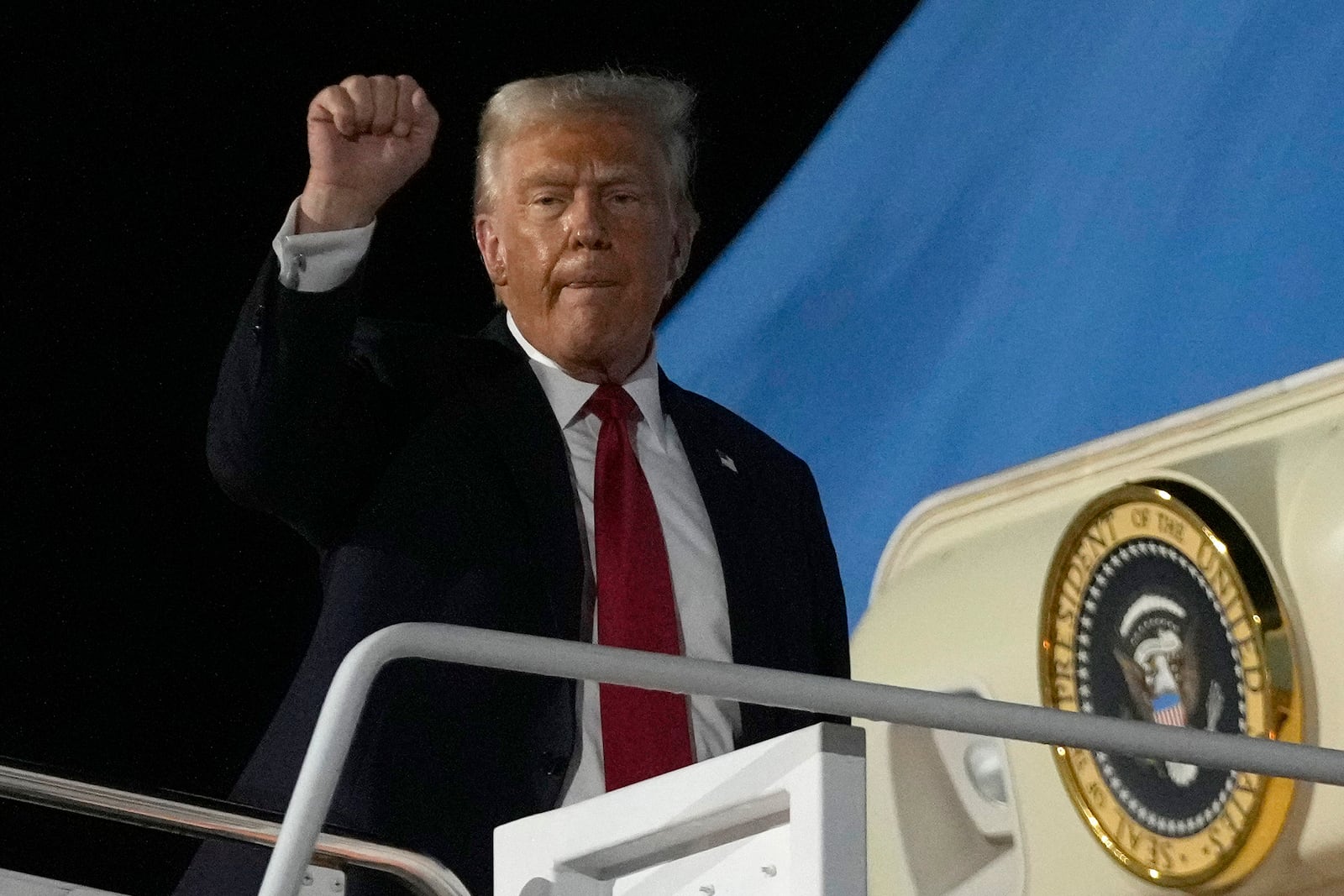 President Donald Trump gestures as he boards Air Force One at the Naval Air Station Joint Reserve Base in New Orleans, Sunday, Feb. 9, 2025. (AP Photo/Ben Curtis)