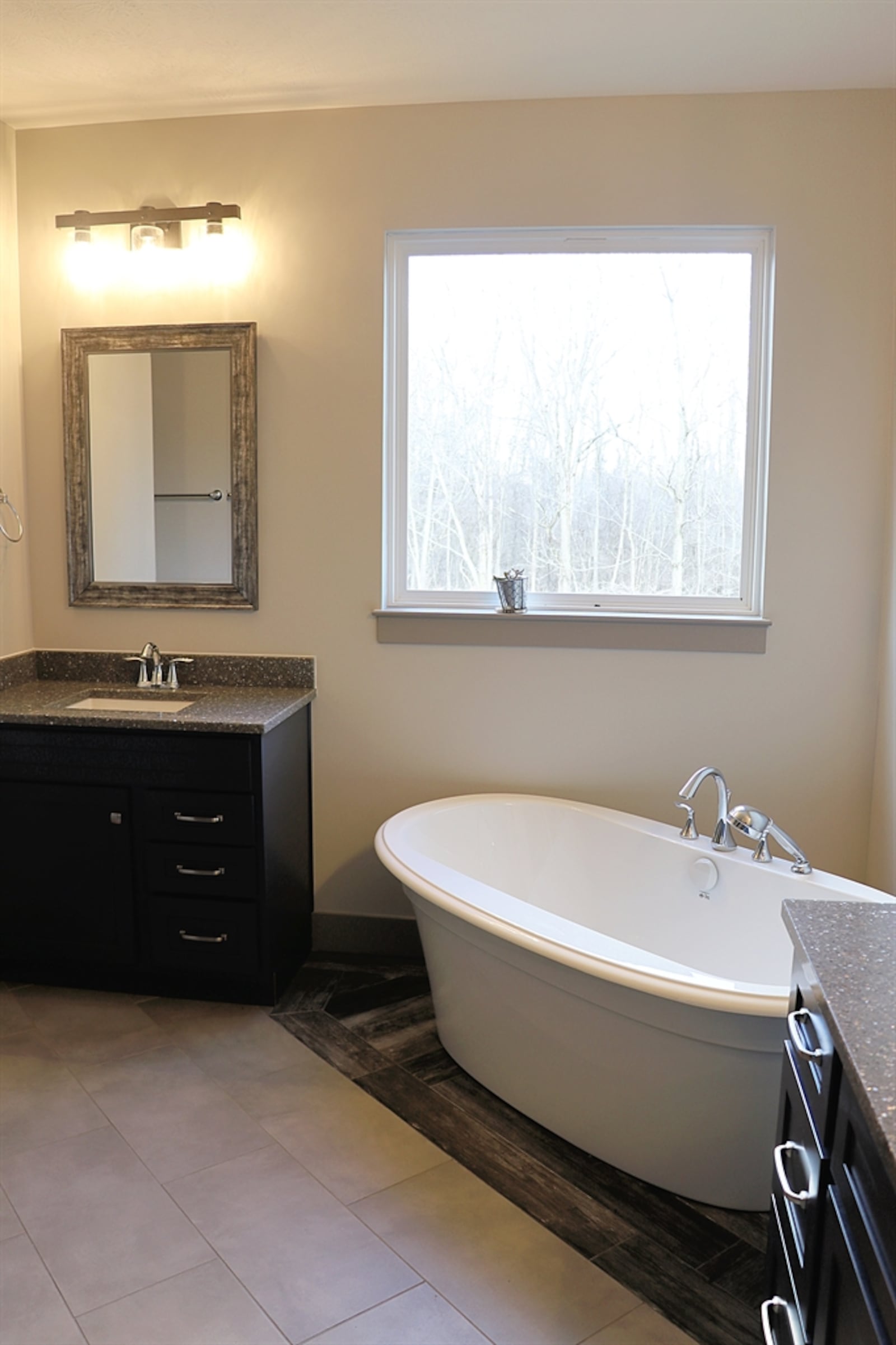 The primary bathroom includes a corner soak tub below a window.