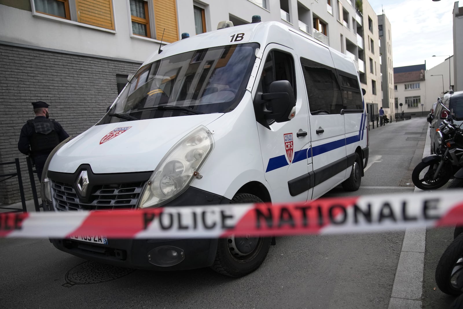 Police officers block a street after the discovery of a huge unexploded World War II-era bomb caused transportation chaos in Paris, that included the suspension of high-speed rail links with London and Brussels and the closure of a vital road artery in the French capital Friday, March 7, 2025 in Saint-Denis, outside Paris. (AP Photo/Christophe Ena)