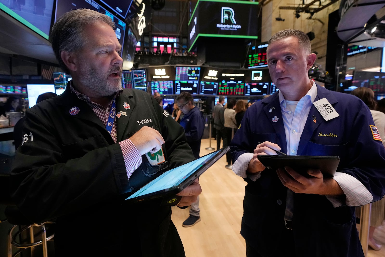 A pair of traders work on the floor of the New York Stock Exchange, Friday, Nov. 8, 2024. (AP Photo/Richard Drew)