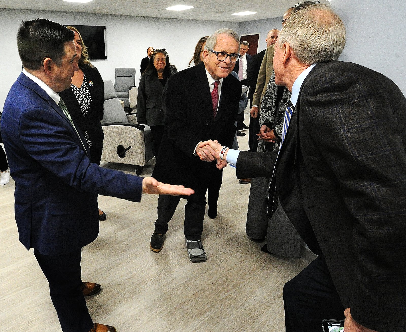 Ohio Gov. Mike DeWine shakes hands with David Covington, President and CEO of RI International at the new Montgomery County Crisis Receiving Center during a ribbon cutting ceremony Monday, April 24, 2023. MARSHALL GORBY\STAFF