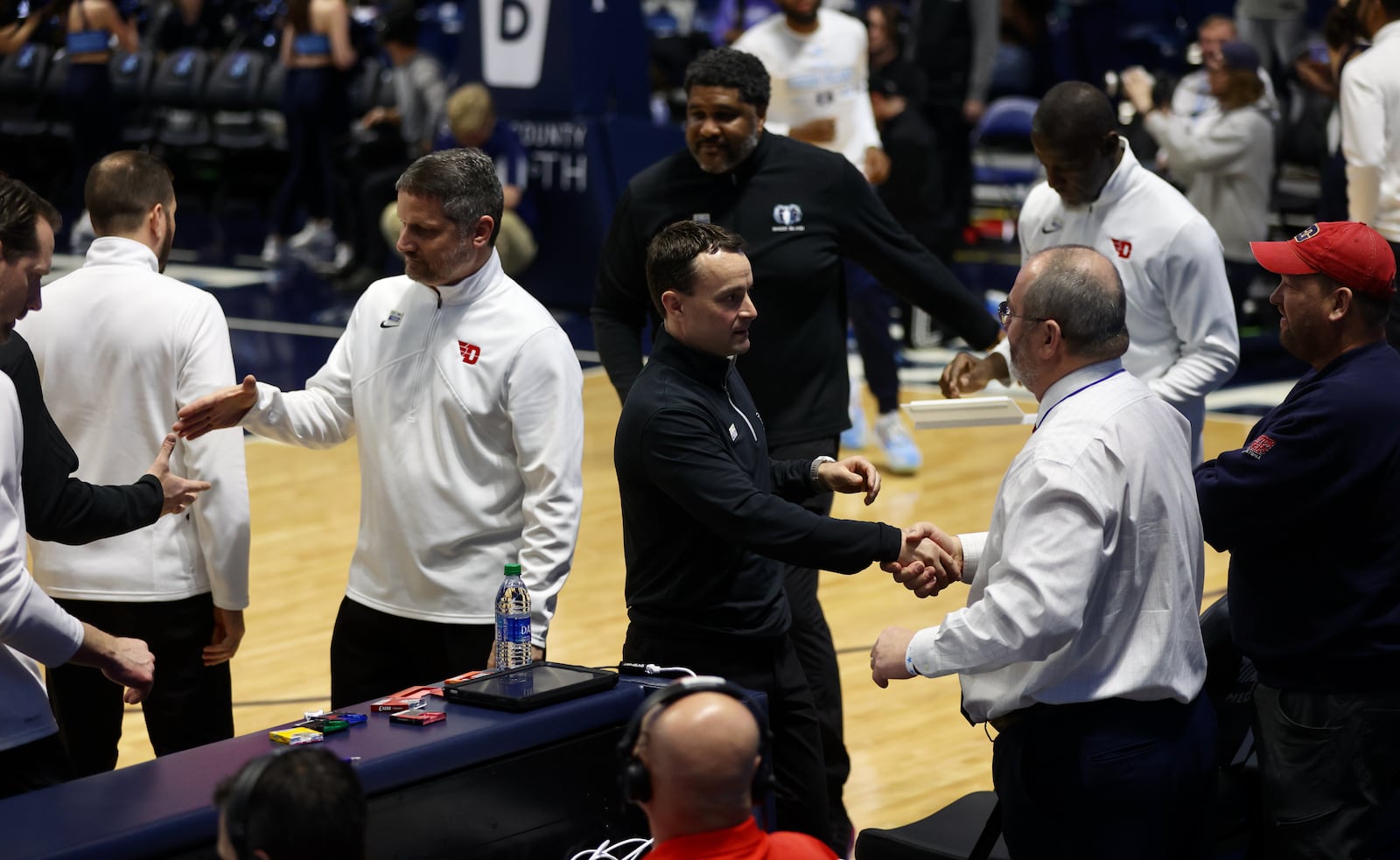 Dayton's Doug Hauschild, right, shakes hands with Rhode Island's Archie Miller before the game on Wednesday, Jan. 25, 2023, at the Ryan Center in Kingston, R.I. David Jablonski/Staff