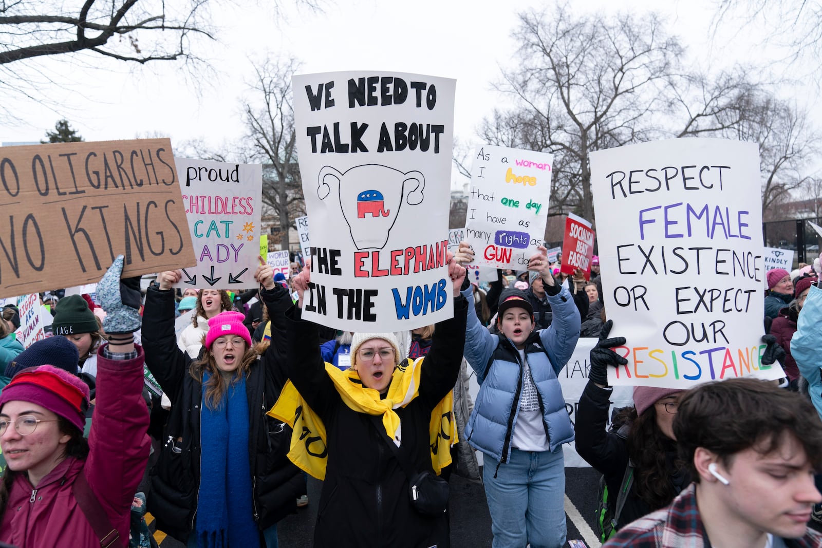 Demonstrators hold signs as they protest President-elect Donald Trump's incoming administration during the People's March, Saturday, Jan. 18, 2025, in Washington. (AP Photo/Jose Luis Magana)