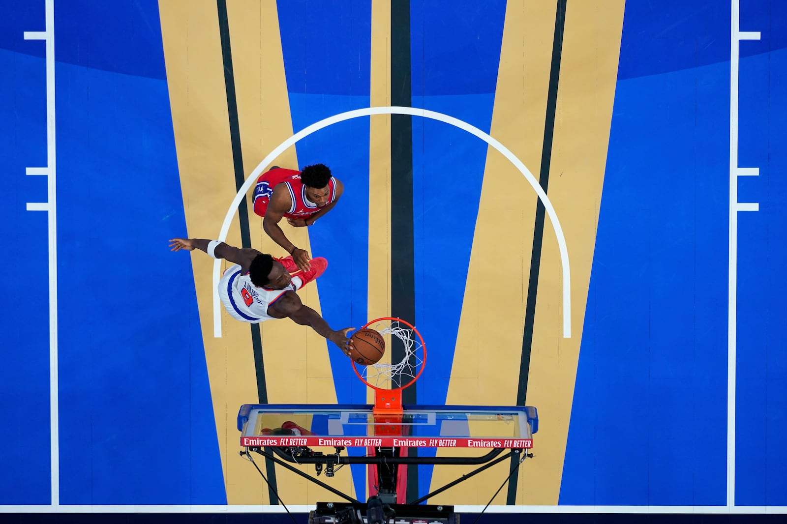 New York Knicks' OG Anunoby, left, dunks past Philadelphia 76ers' Kyle Lowry during the second half of an Emirates NBA Cup basketball game, Tuesday, Nov. 12, 2024, in Philadelphia. (AP Photo/Matt Slocum)