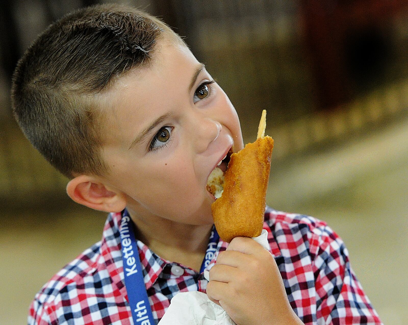 Maverick Ellison, 6, enjoys cheese on a stick Tuesday Aug. 2, 2022 at the Greene County Fair. MARSHALL GORBY\STAFF