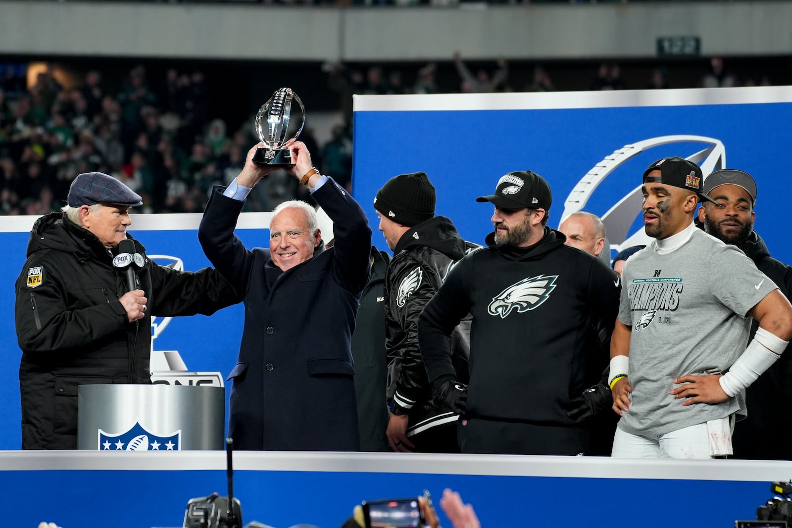 Philadelphia Eagles owner Jeffrey Lurie celebrates with the trophy after their win against the Washington Commanders in the NFC Championship NFL football game, Sunday, Jan. 26, 2025, in Philadelphia. (AP Photo/Chris Szagola)