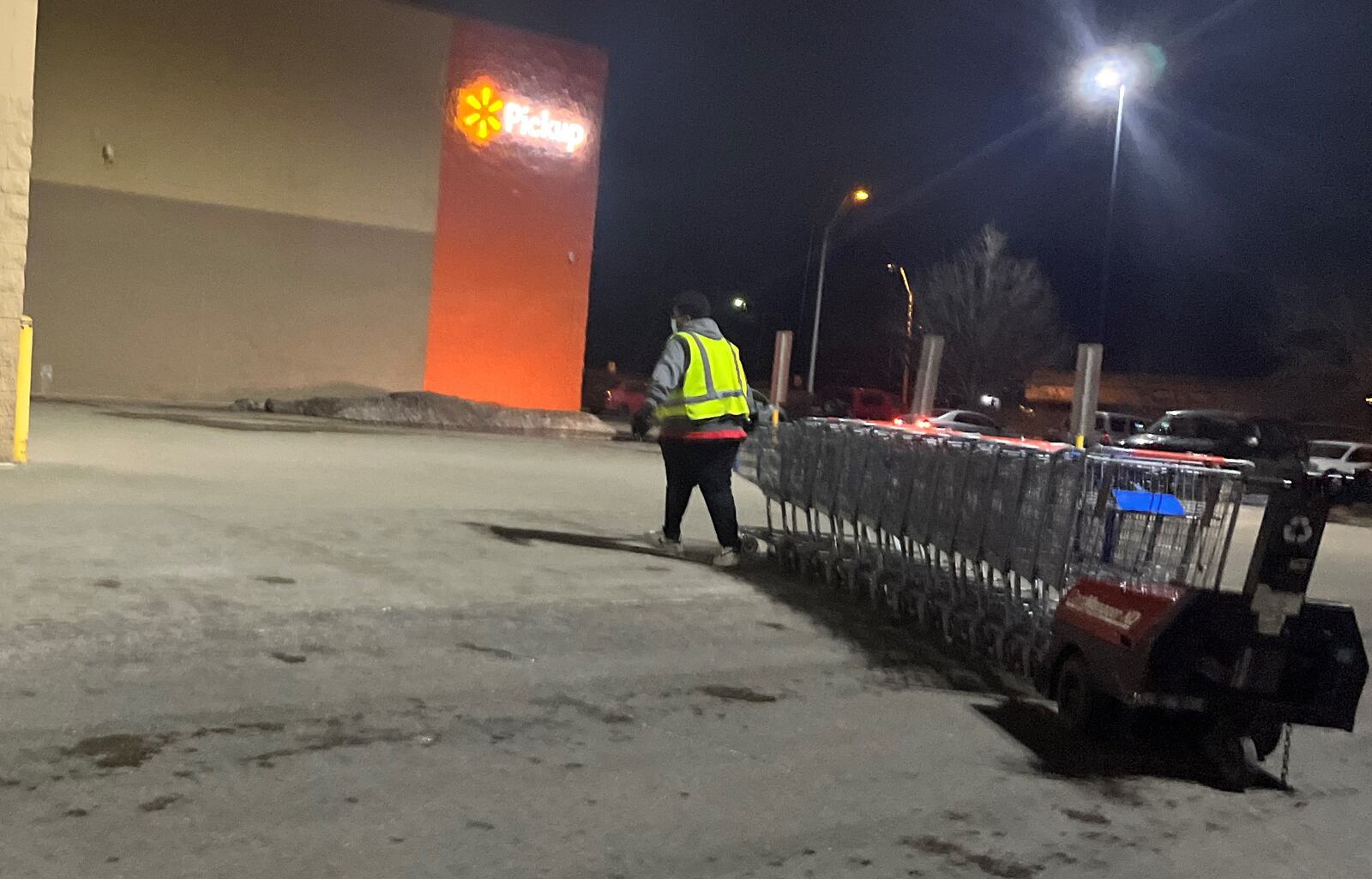 An employee at a local big box store collects shopping carts. CORNELIUS FROLIK / STAFF