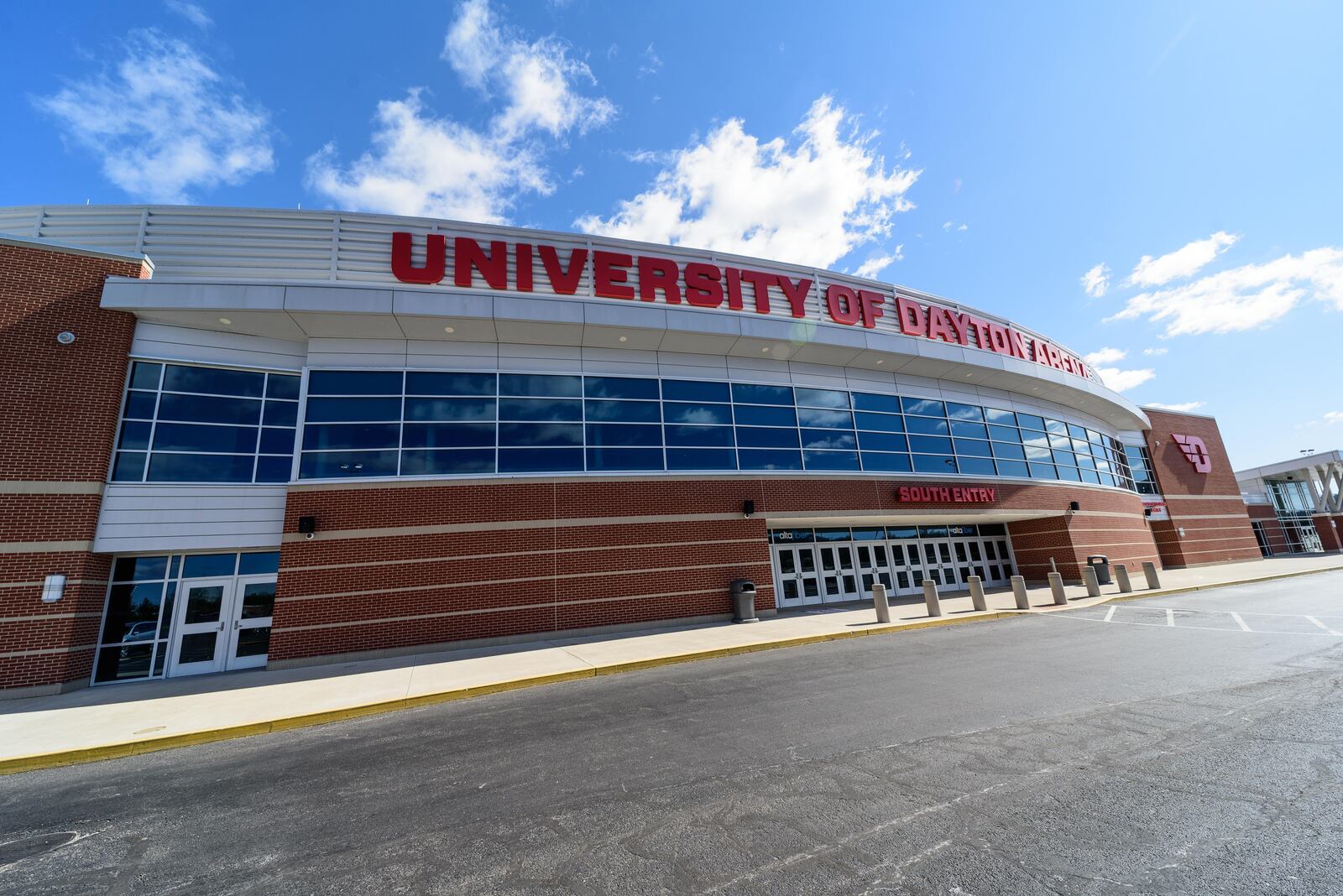 On St. Patrick's Day 2024, workers put the finishing touches on the basketball court installation for the First Four of the NCAA Division I Men’s Basketball Championship at UD Arena which will take place on March 19 & 20, 2024. TOM GILLIAM / CONTRIBUTING PHOTOGRAPHER