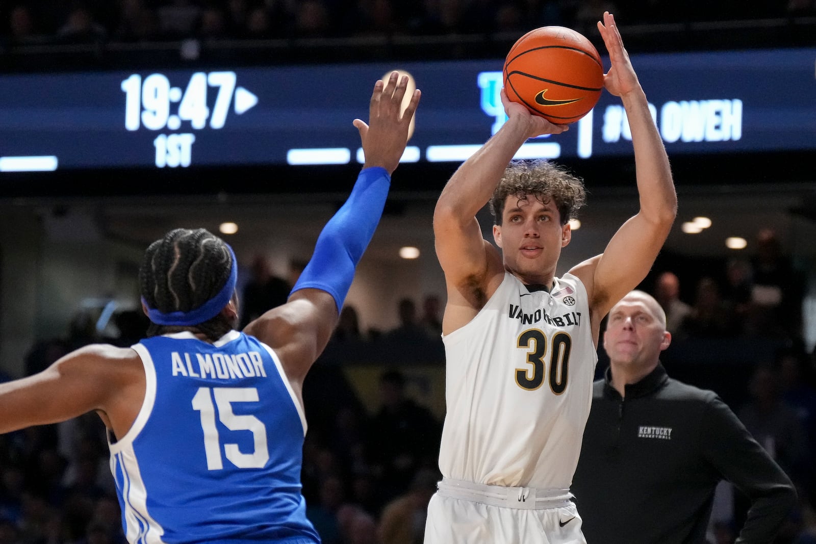 Vanderbilt guard Chris Manon (30) shoots the ball over Kentucky forward Ansley Almonor (15) during the first half of an NCAA college basketball game Saturday, Jan. 25, 2025, in Nashville, Tenn. (AP Photo/George Walker IV)