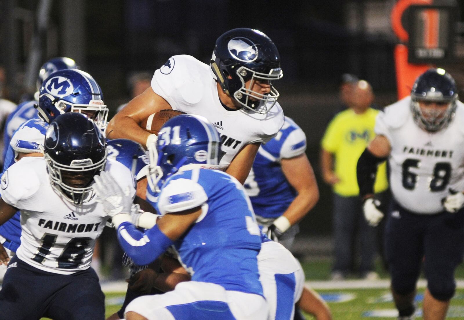 Chris Thompson of Fairmont (top) makes a short gain. Fairmont defeated host Miamisburg 25-24 in a Week 6 high school football game on Friday, Sept. 28, 2018. MARC PENDLETON / STAFF