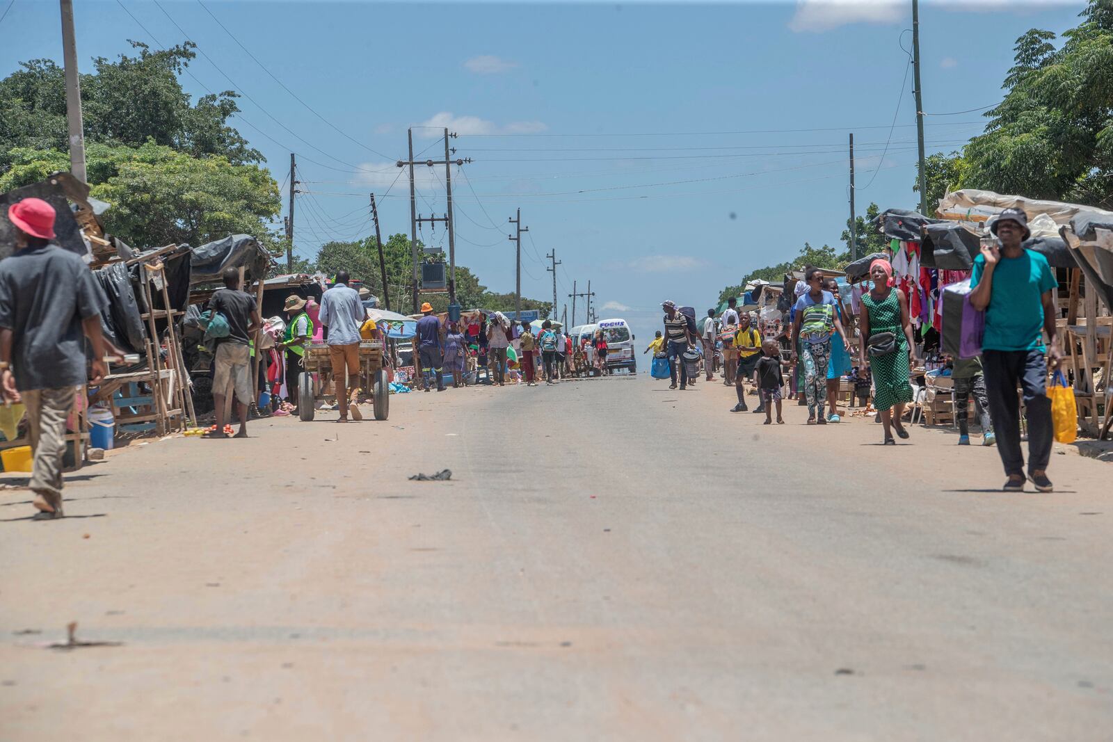 Residents walk in the Epworth neighbourhood of Harare, Zimbabwe, Friday, Feb. 7, 2025. (AP Photo/Aaron Ufumeli)