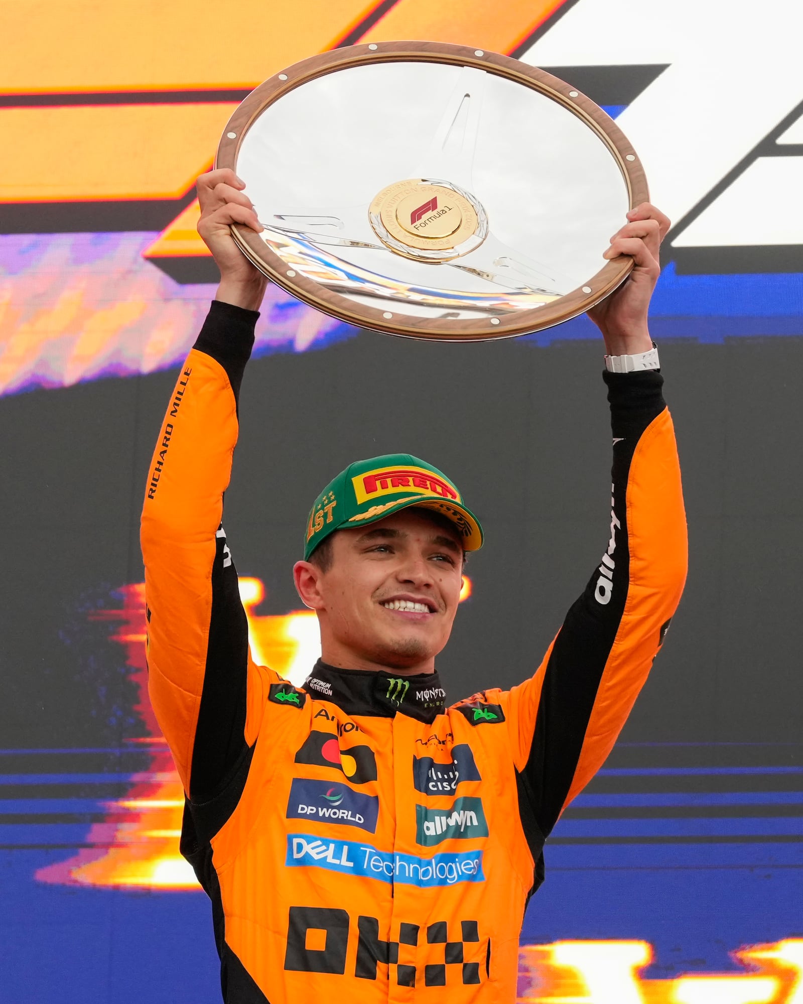 McLaren driver Lando Norris of Britain celebrates on the podium after winning the Australian Formula One Grand Prix at Albert Park, in Melbourne, Australia, Sunday, March 16, 2025. (AP Photo/Asanka Brendon Ratnayake)