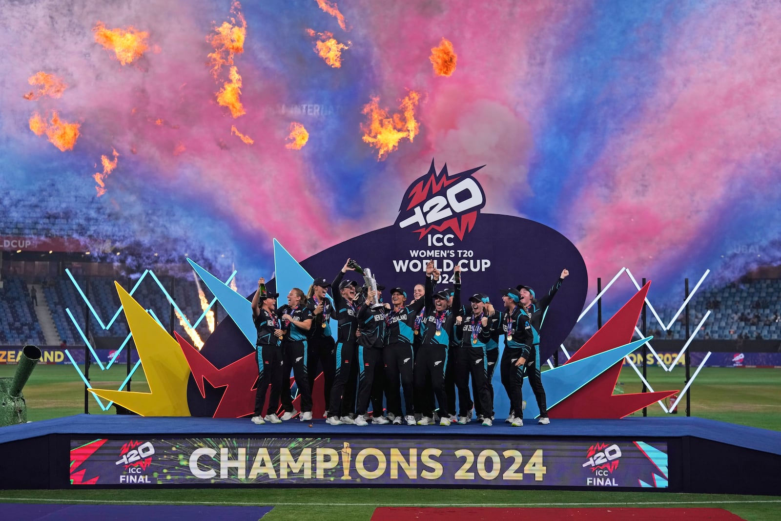 New Zealand's players celebrate with the trophy after winning the ICC Women's T20 World Cup 2024 final match against South Africa at Dubai International Cricket Stadium, United Arab Emirates, Sunday, Oct. 20, 2024. (AP Photo/Altaf Qadri)