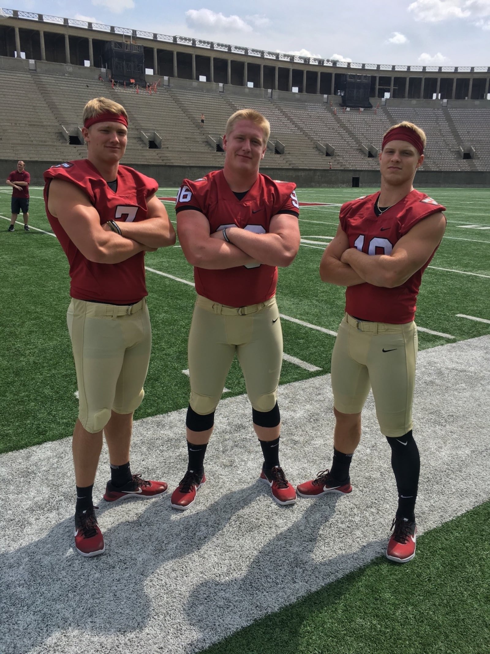 Owen Holt (left) with a couple of his football teammates at Harvard . He spent two years as a Harvard quarterback before switching to baseball. CONTRIBUTED