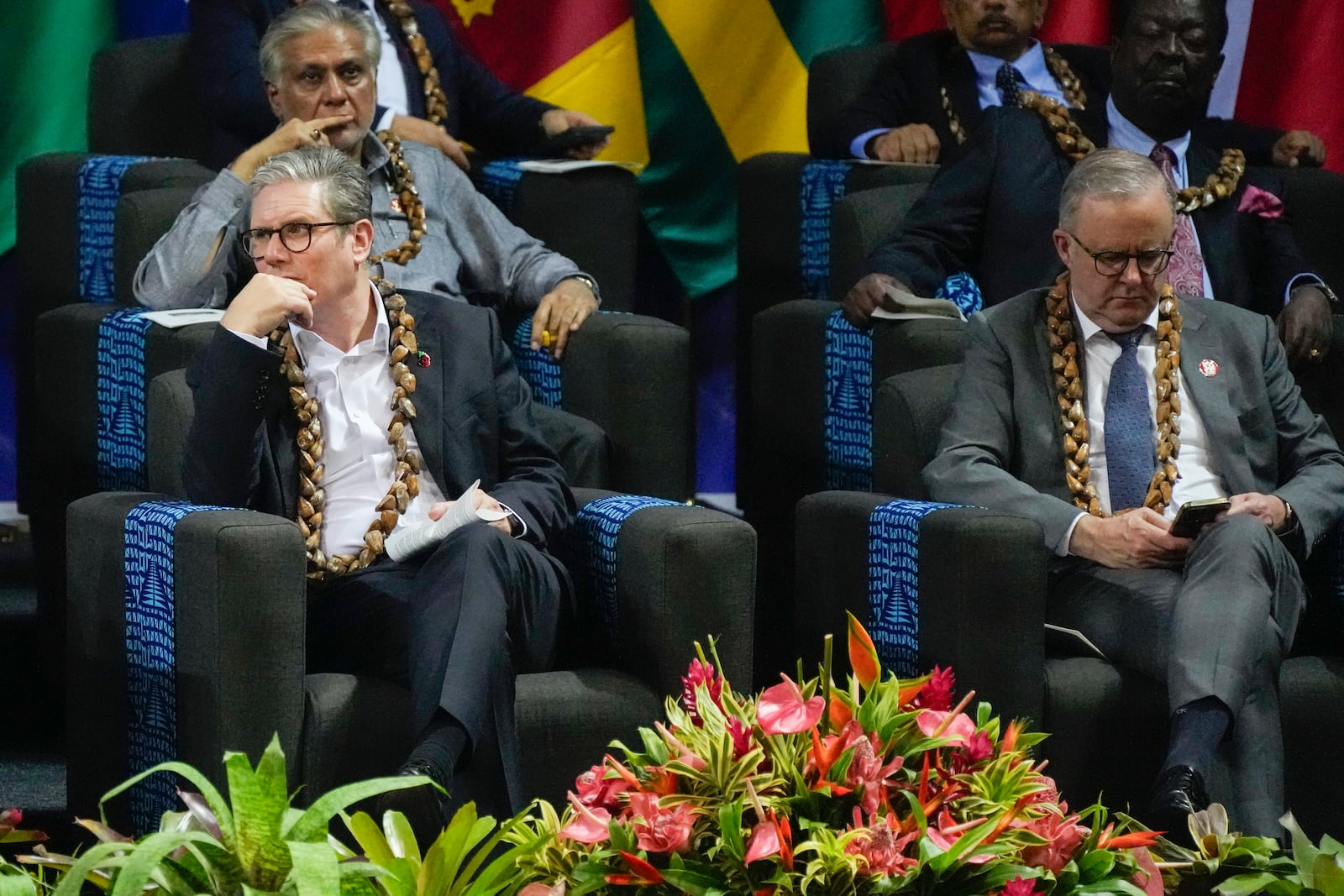 British Prime Minister Keir Starmer, left, and Australian Prime Minister Anthony Albanese react during the opening ceremony for the Commonwealth Heads of Government meeting in Apia, Samoa, Friday, Oct. 25, 2024. (AP Photo/Rick Rycroft/Pool)