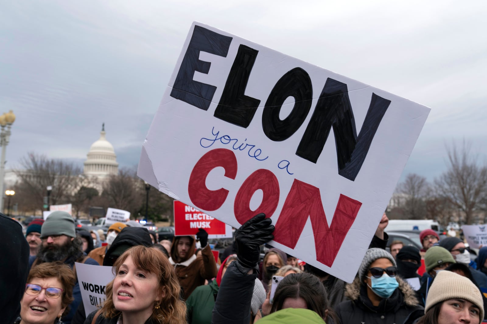 People protest during a rally against Elon Musk outside the U.S. Department of Labor in Washington, Wednesday, Feb. 5, 2025. (AP Photo/Jose Luis Magana)