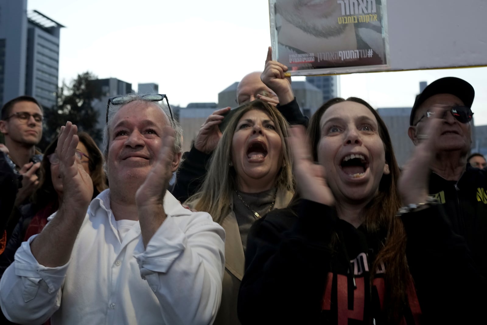 Relatives and friends of people killed and abducted by Hamas and taken into Gaza, react as they gather in Tel Aviv, Israel on Sunday, Jan. 19, 2025. (AP Photo/Maya Alleruzzo)