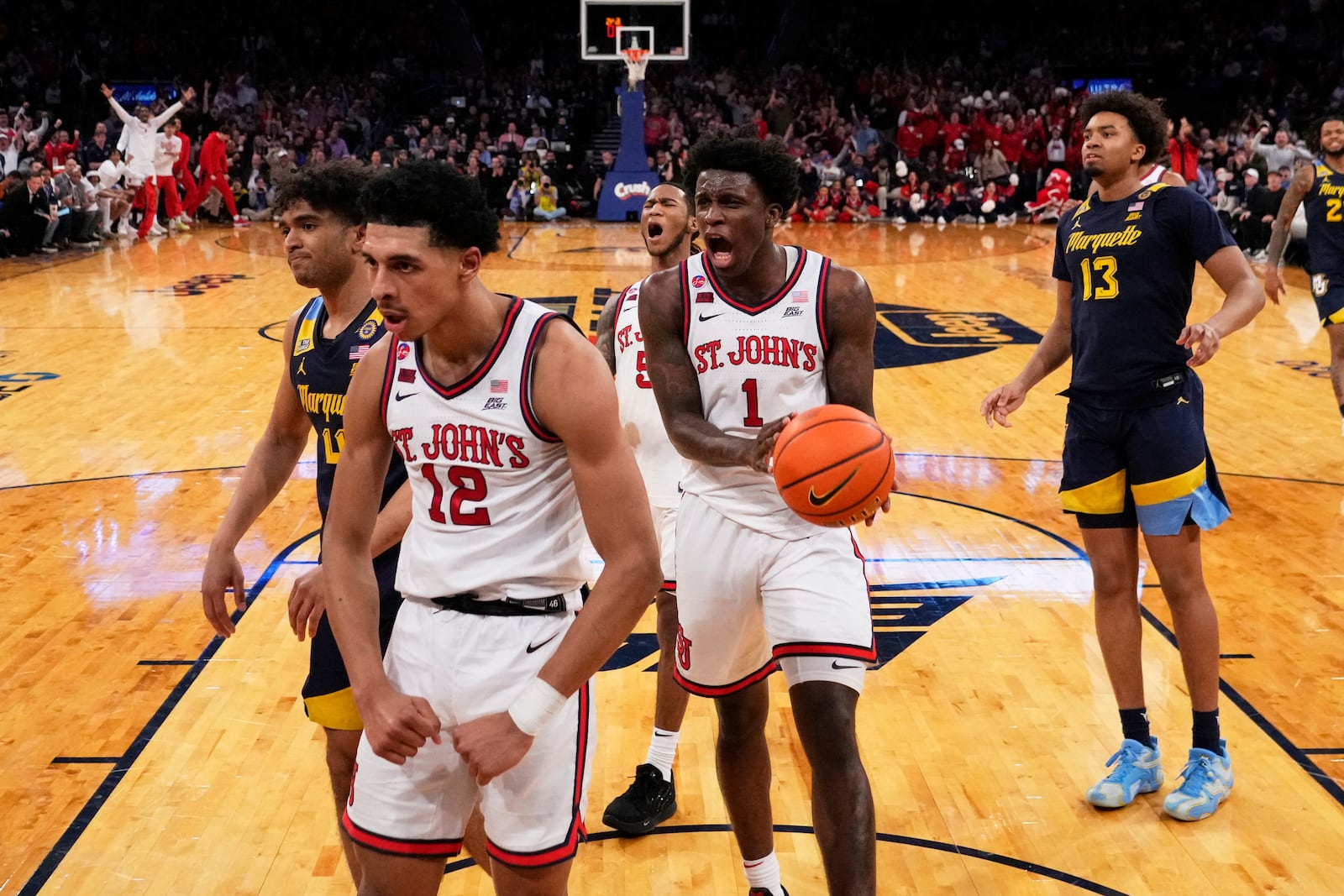 St. John's's Kadary Richmond (1) celebrates after RJ Luis Jr. (12) scored during the first half of an NCAA college basketball game against the Marquette in the semifinals of the Big East tournament Friday, March 14, 2025, in New York. (AP Photo/Frank Franklin II)