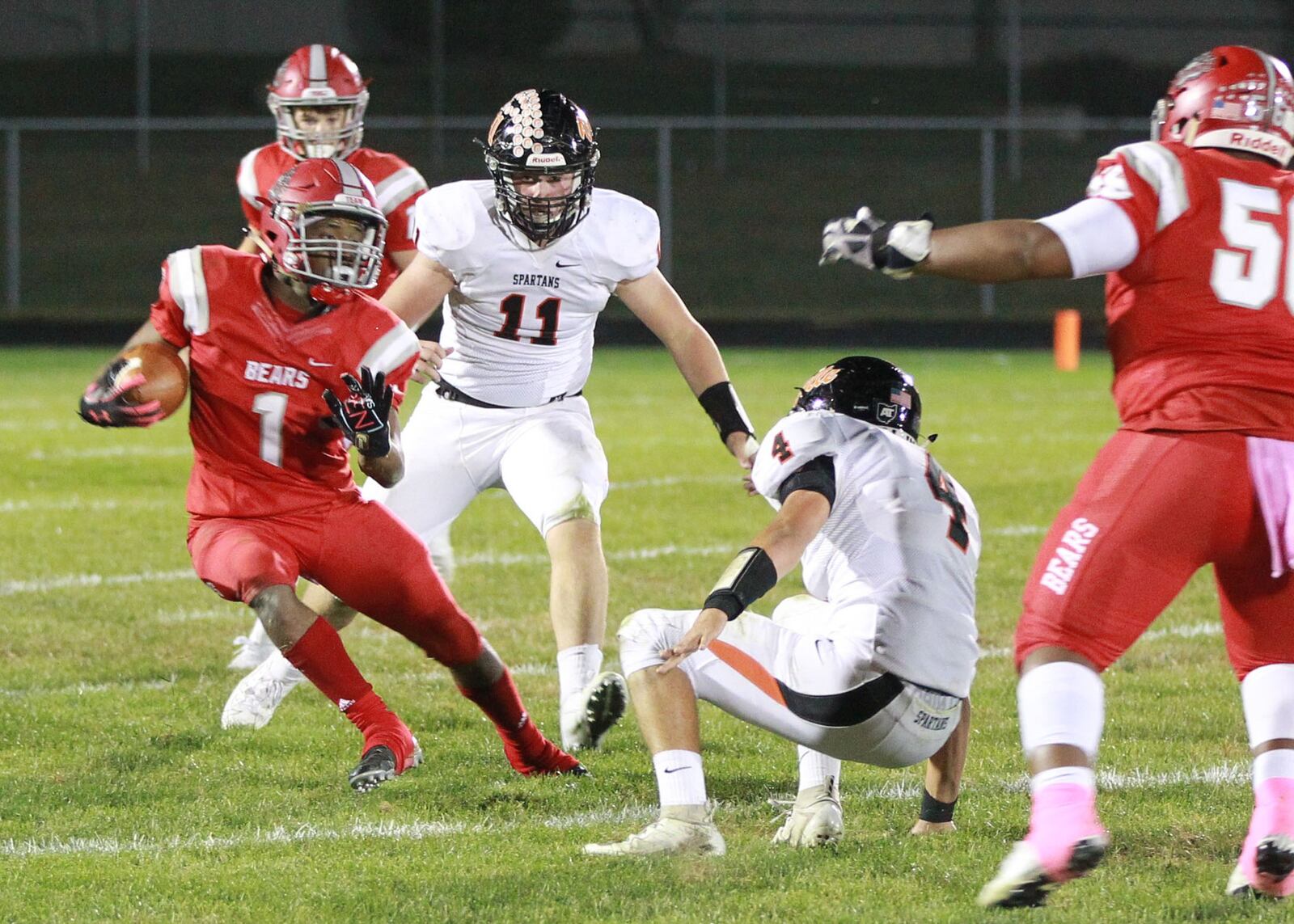 Jerron Lander of Northridge (with ball) eludes Waynesville defenders Luke Zebell (11) and Caleb Lamb. Waynesville defeated host Northridge 23-8 in a Week 9 high school football game on Thursday, Oct. 24, 2019. MARC PENDLETON / STAFF