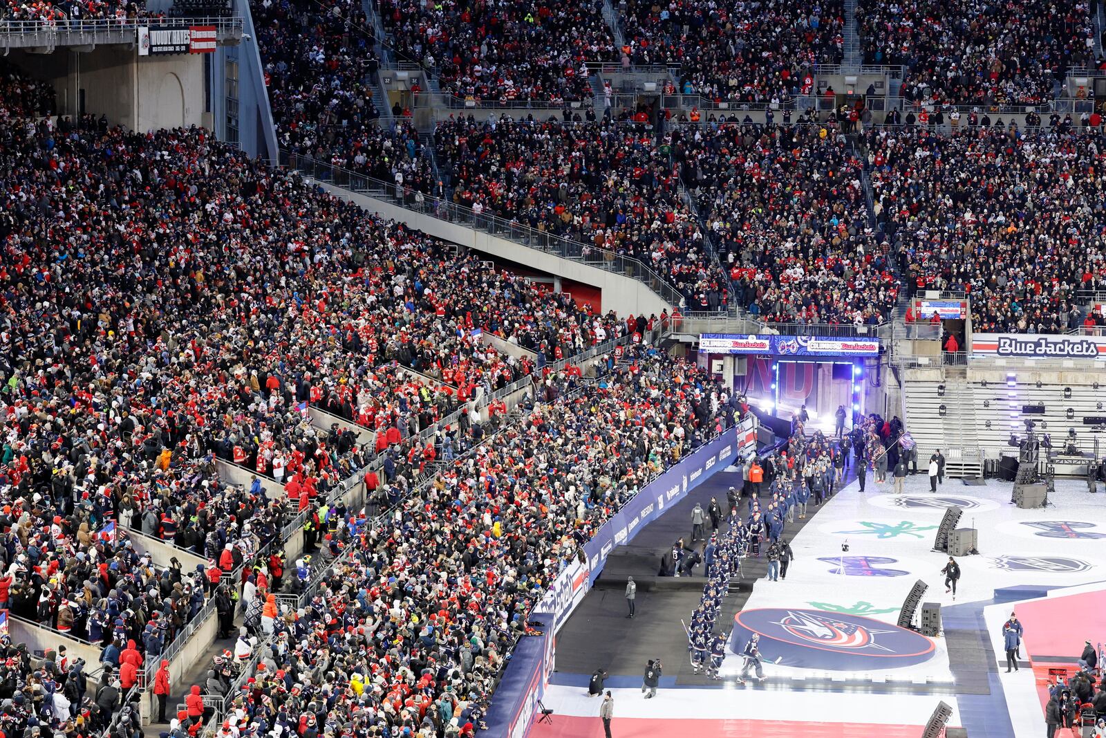 The Columbus Blue Jackets enter Ohio Stadium before the start of the Stadium Series NHL hockey game between the against the Detroit Red Wings Saturday, March 1, 2025, in Columbus, Ohio. (AP Photo/Jay LaPrete)