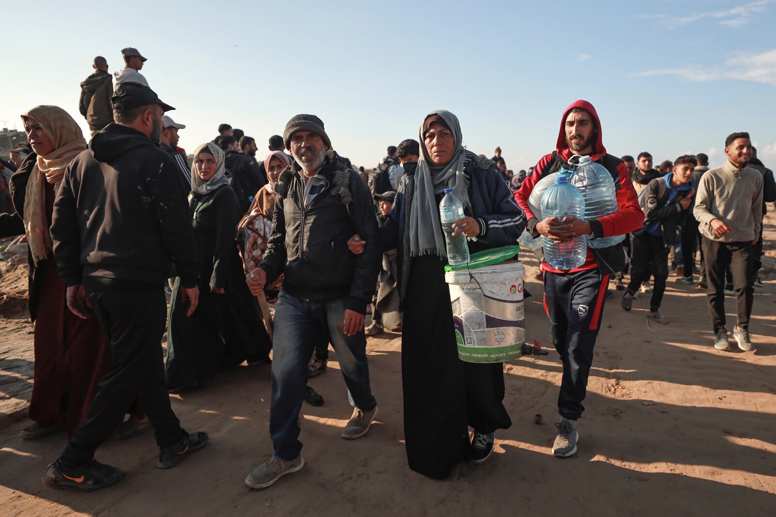 Displaced Palestinians arrive in the northern Gaza Strip, following Israel's decision to allow thousands of them to go back for the first time since the early weeks of the 15-month war with Hamas, Monday, Jan. 27, 2025. (AP Photo/Abed Hajjar)