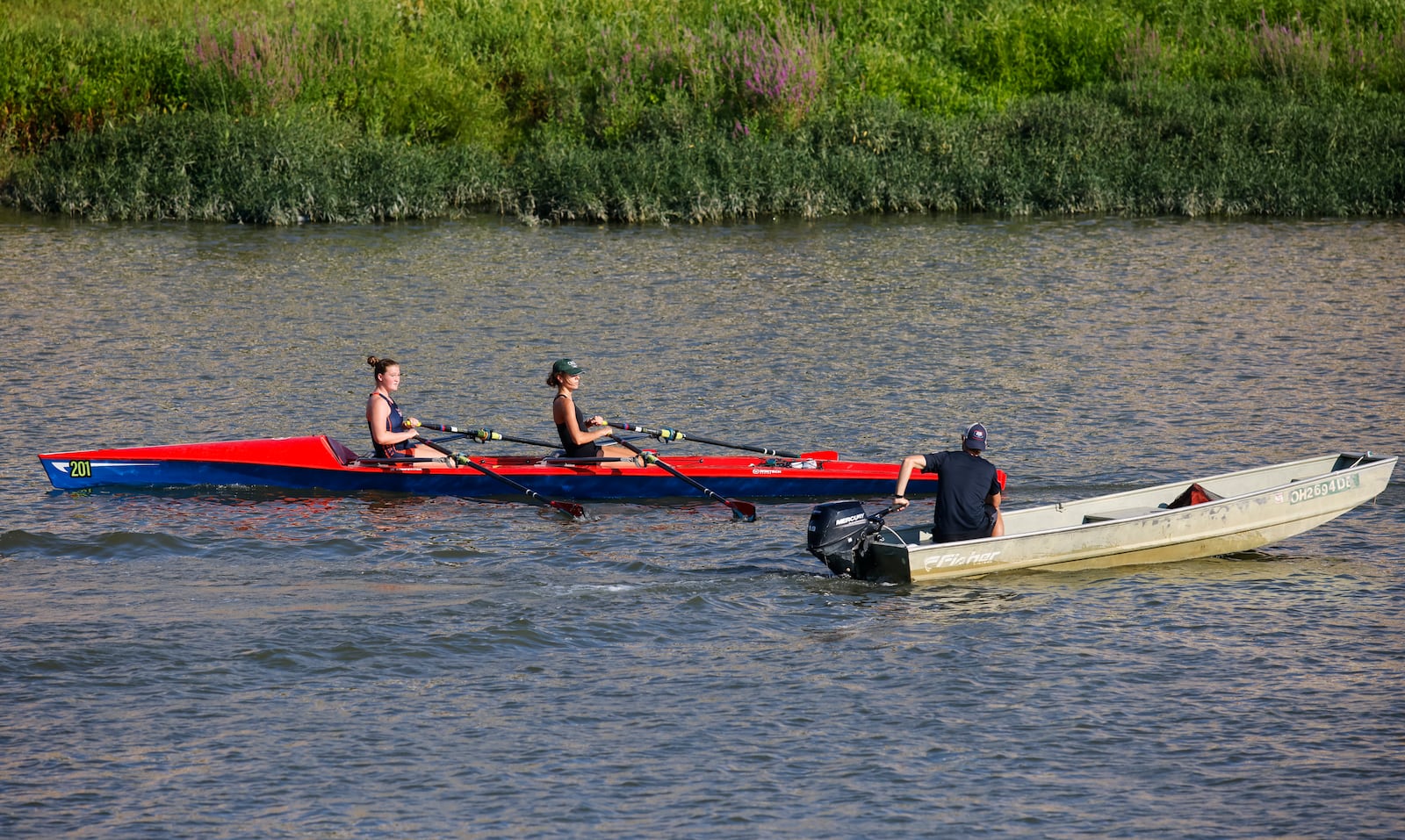 Annelise Hahl, 16, from North Carolina, left, and Annalie Duncomb, 16, from Mason, practice with guidance from assistant coach Chris Bak Thursday, Aug. 25, 2022 in Hamilton. Duncomb, Hahl and others with The Great Miami Rowing Club are heading to Wales where they will be training for and then competing in the 2022 World Coastal Championships and Beach Sprint Finals. NICK GRAHAM/STAFF