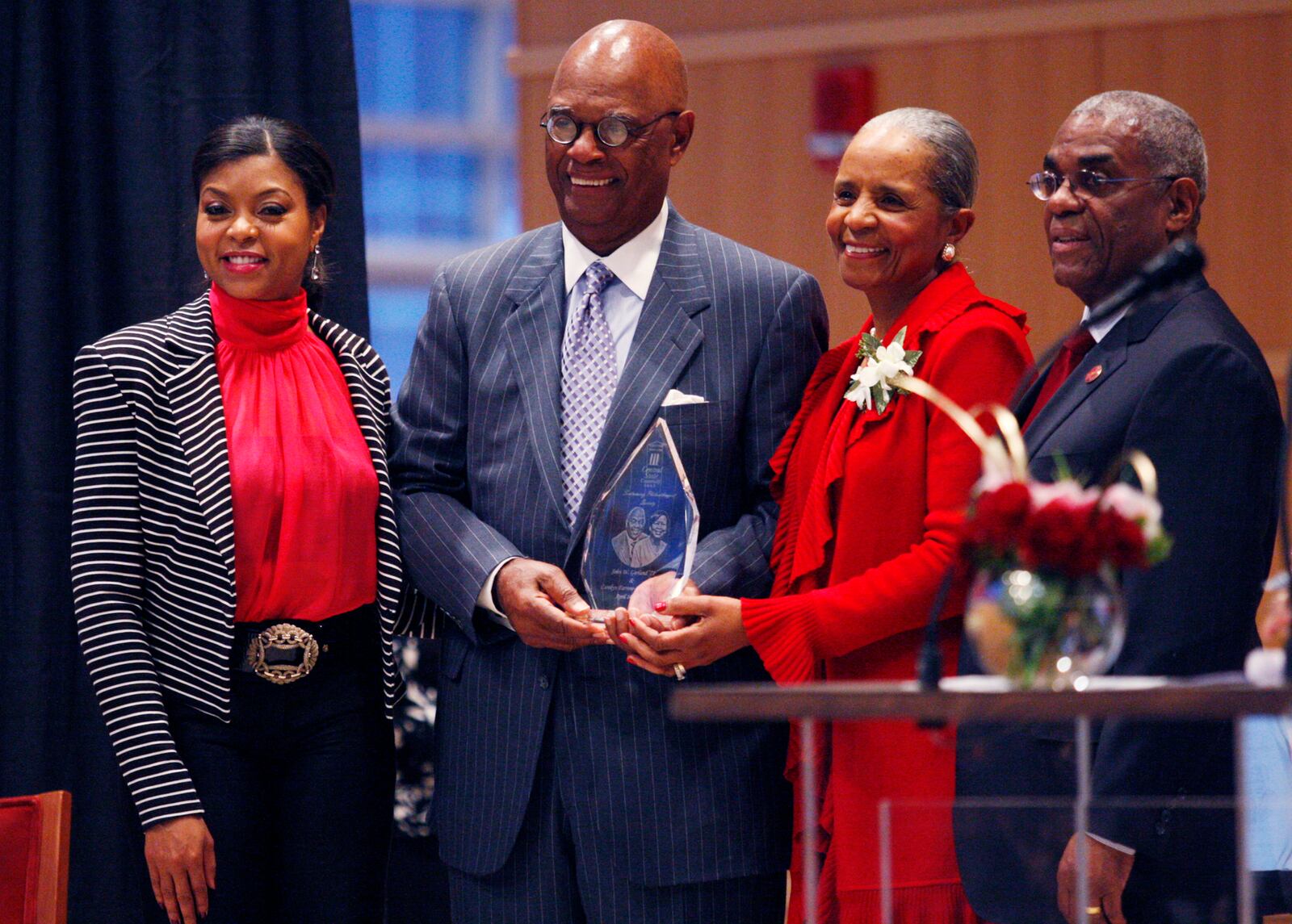 Academy award winning actress Taraji P. Henson, left, honors 2011 inductees Ernie and Della Green, middle, with Central State University President John Garland, right, during the university's A Night for Philanthropy at the Schuster Center in 2011. DDN FILE