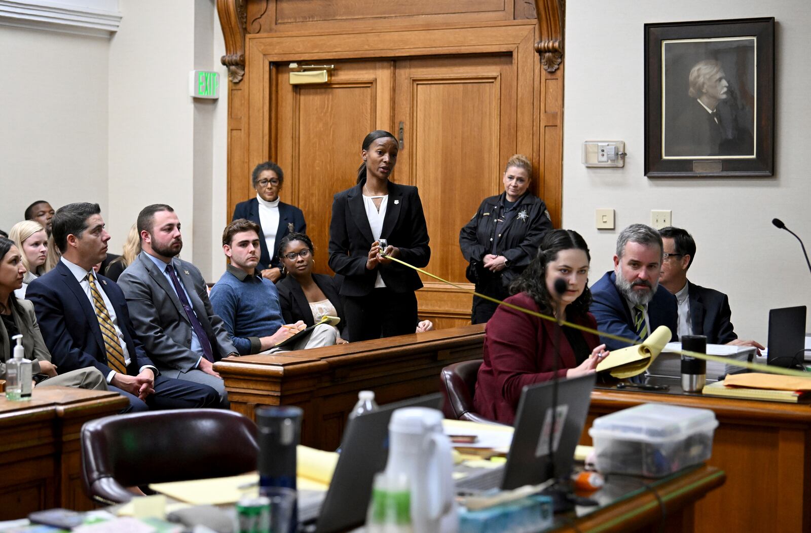 GBI Crime Scene Specialist Daniella Stuart, center, takes a measurement as she testifies during a trial of Jose Ibarra, accused of killing a Georgia nursing student earlier this year, at Athens-Clarke County Superior Court, Friday, Nov. 15, 2024, in Athens, Ga.(Hyosub Shin/Atlanta Journal-Constitution via AP, Pool)