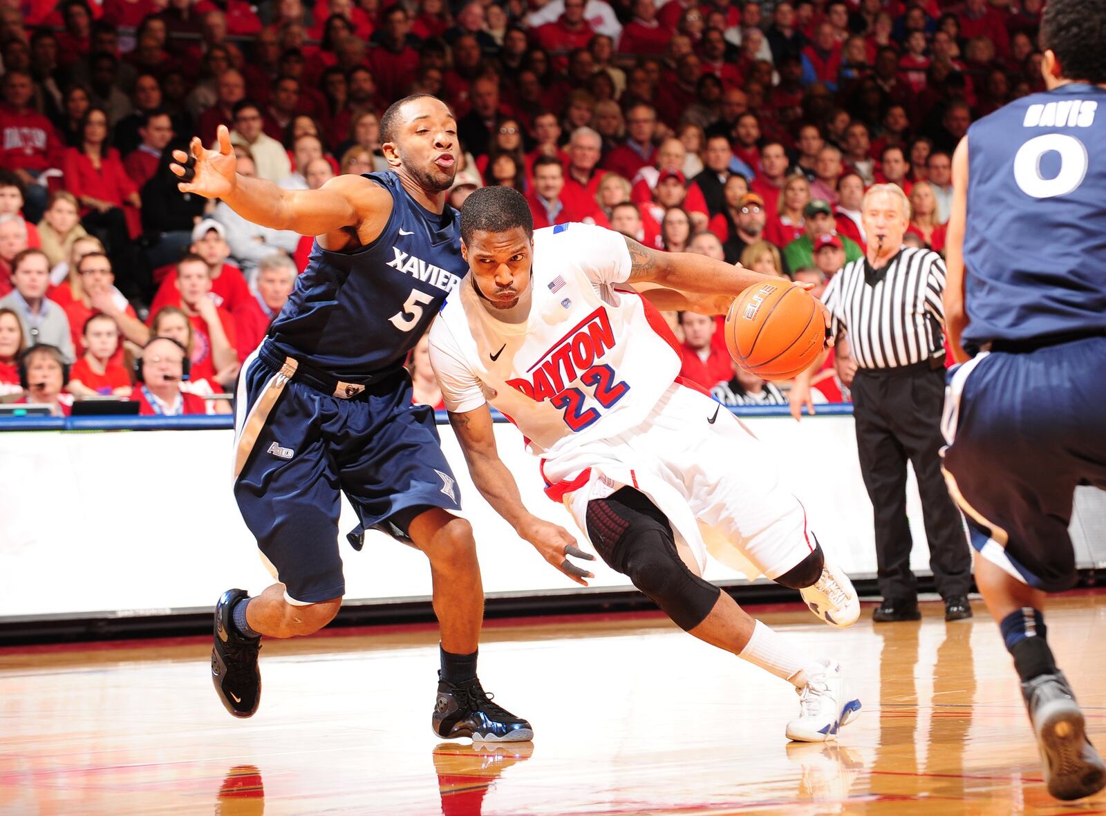 Former Xavier basketball player Dez Wells (5) guards Dayton Flyer Paul Williams in a Jan. 21, 2012, game. Wells was expelled in 2012 after he was accused of sexual assault. He settled his lawsuit against the university this year for an undisclosed amount of money. ERIK SCHELKUN / CONTRIBUTED