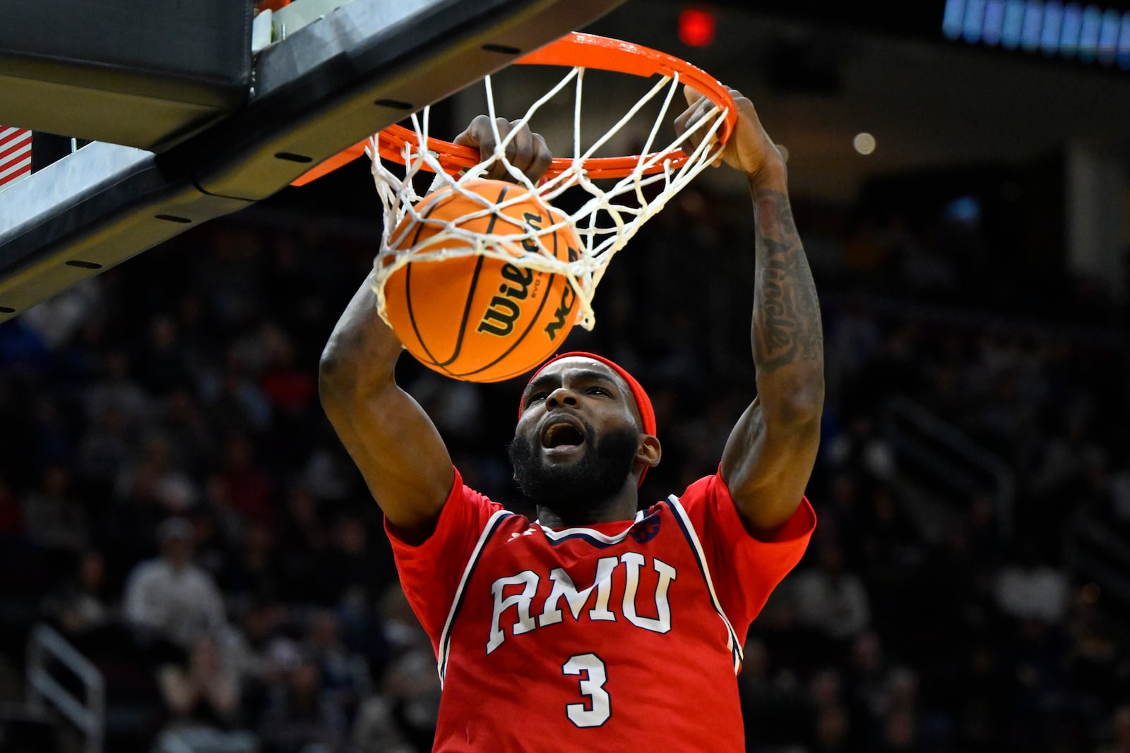 Robert Morris guard Amarion Dickerson (3) dunks in the first half against Alabama in the first round of the NCAA college basketball tournament, Friday, March 21, 2025, in Cleveland. (AP Photo/David Richard)