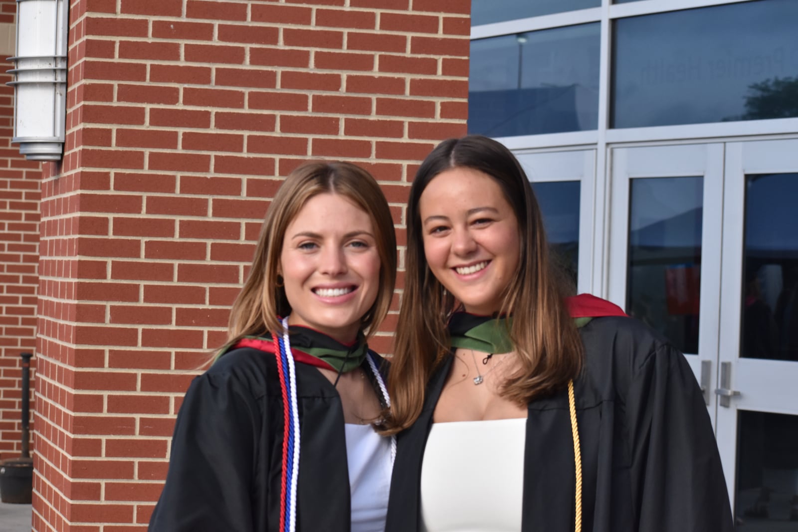 Maria Wellmann, of Baltimore, and Madeline Sautbine, of Indianapolis, receiving degrees in health science from the University of Dayton on Sunday, May 5, 2024, and Sautbine said she planned to go into nursing. SAM WILDOW\STAFF