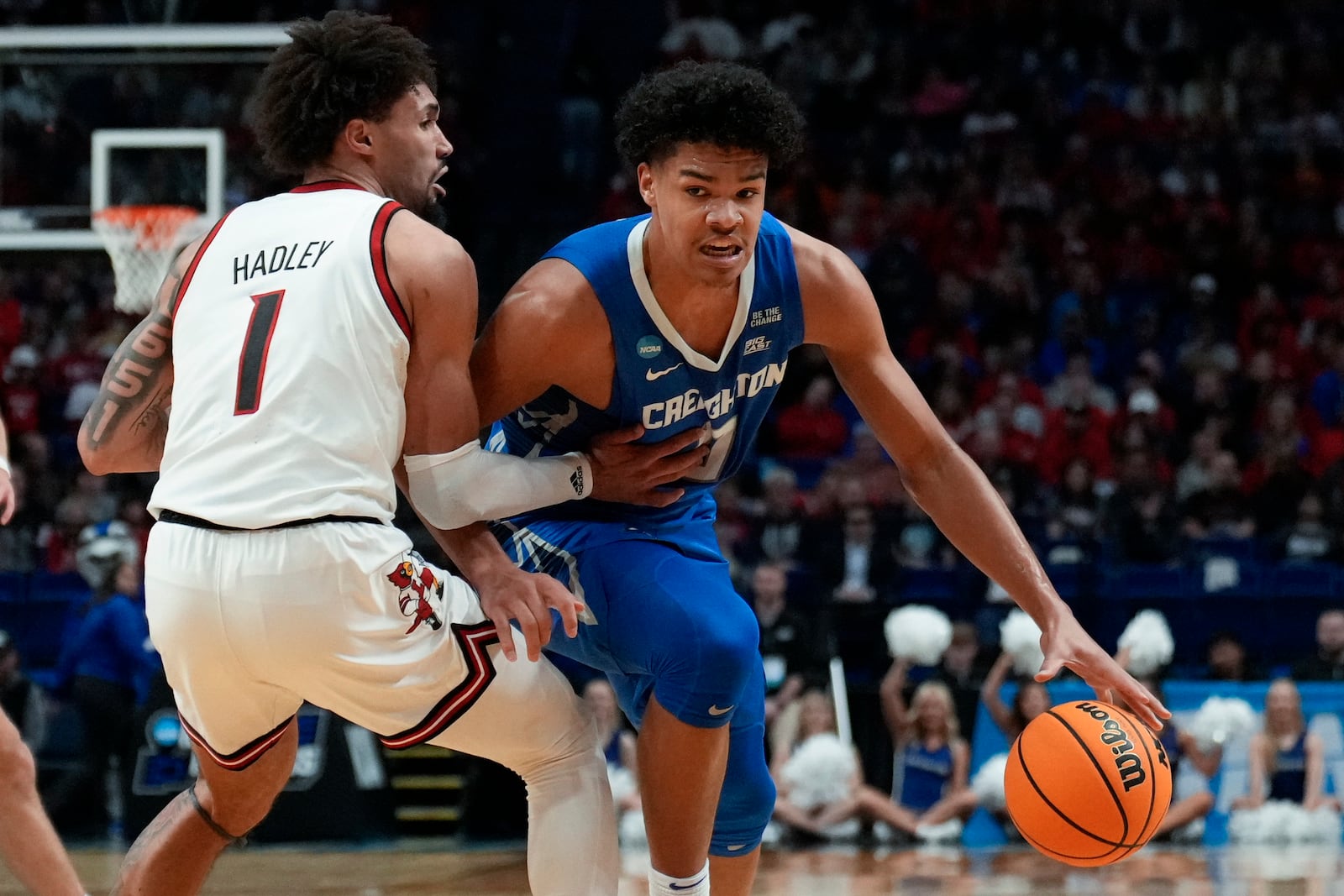 Creighton forward Jasen Green (0) drives on Louisville guard J'Vonne Hadley (1) during the first half in the first round of the NCAA college basketball tournament, Thursday, March 20, 2025, in Lexington, Ky. (AP Photo/Brynn Anderson)