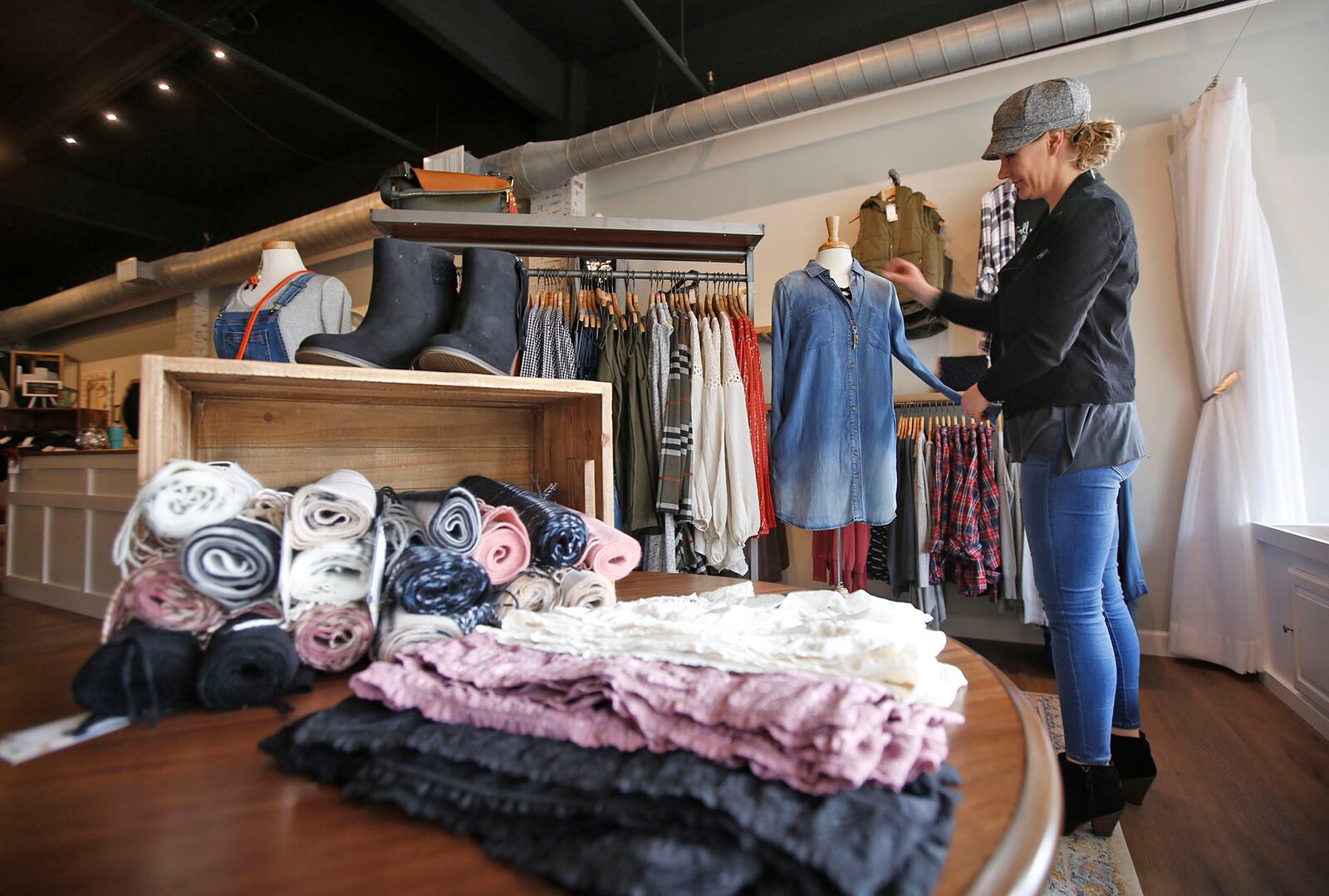 Grace Lane Boutique is one of 32 new business to open in downtown Dayton in 2018. Store owner Danielle Goodman adjusts a mannequin. TY GREENLEES / STAFF