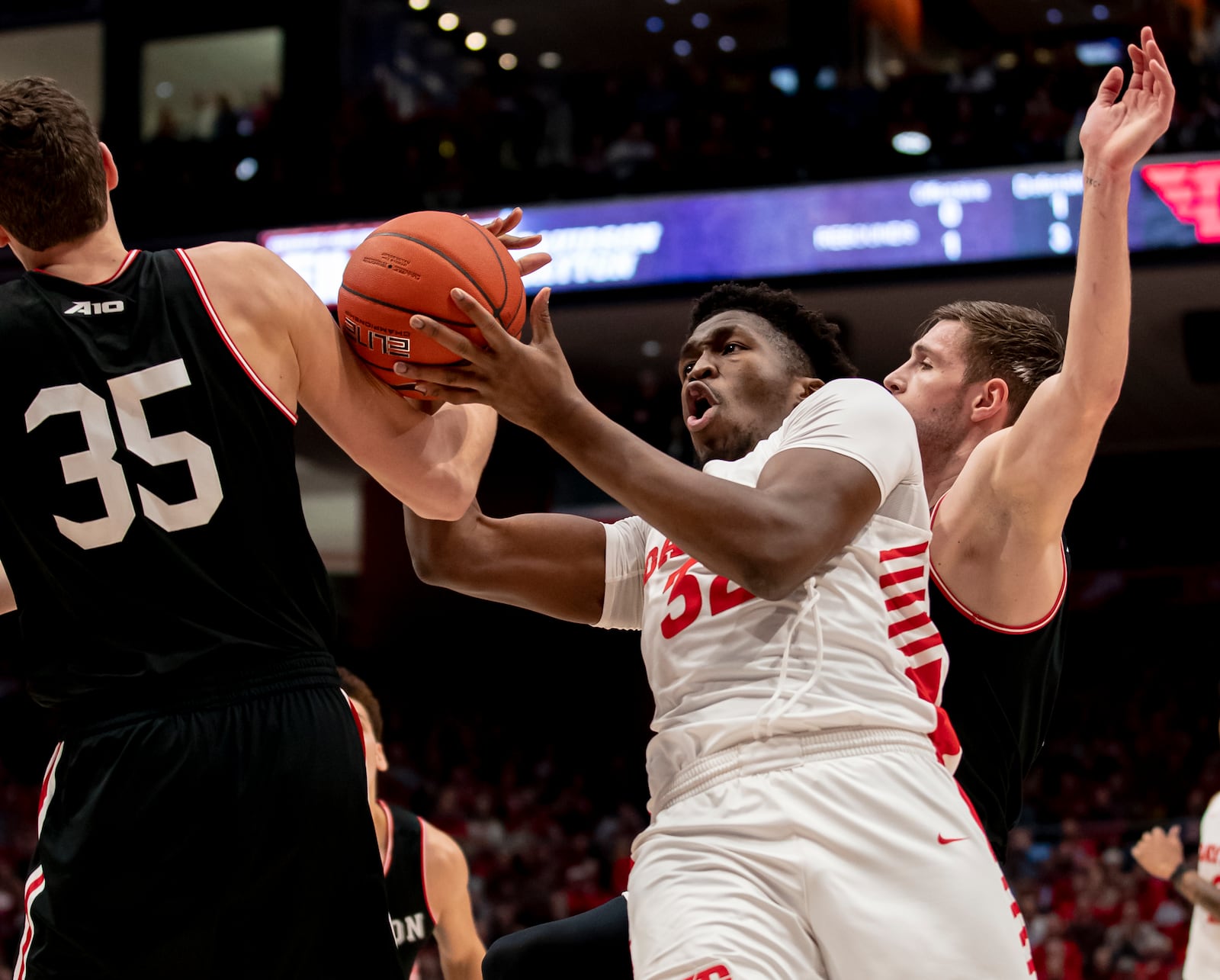 DAYTON, OH - FEBRUARY 28: Jordy Tshimanga #32 of the Dayton Flyers has the ball tied up while shooting by Luka Brajkovic #35 of the Davidson Wildcats during the first half at UD Arena on February 28, 2020 in Dayton, Ohio. (Photo by Michael Hickey/Getty Images)