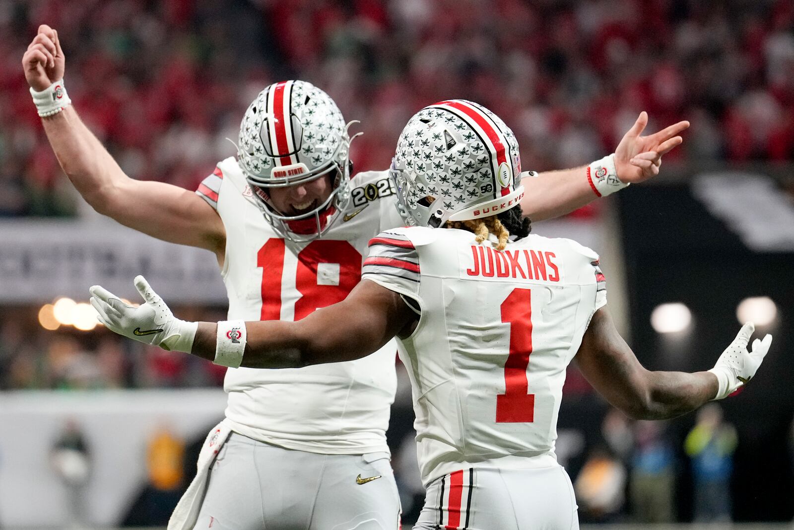 Ohio State running back Quinshon Judkins celebrates after scoring with quarterback Will Howard during first half of the College Football Playoff national championship game against Notre Dame Monday, Jan. 20, 2025, in Atlanta. (AP Photo/Brynn Anderson)